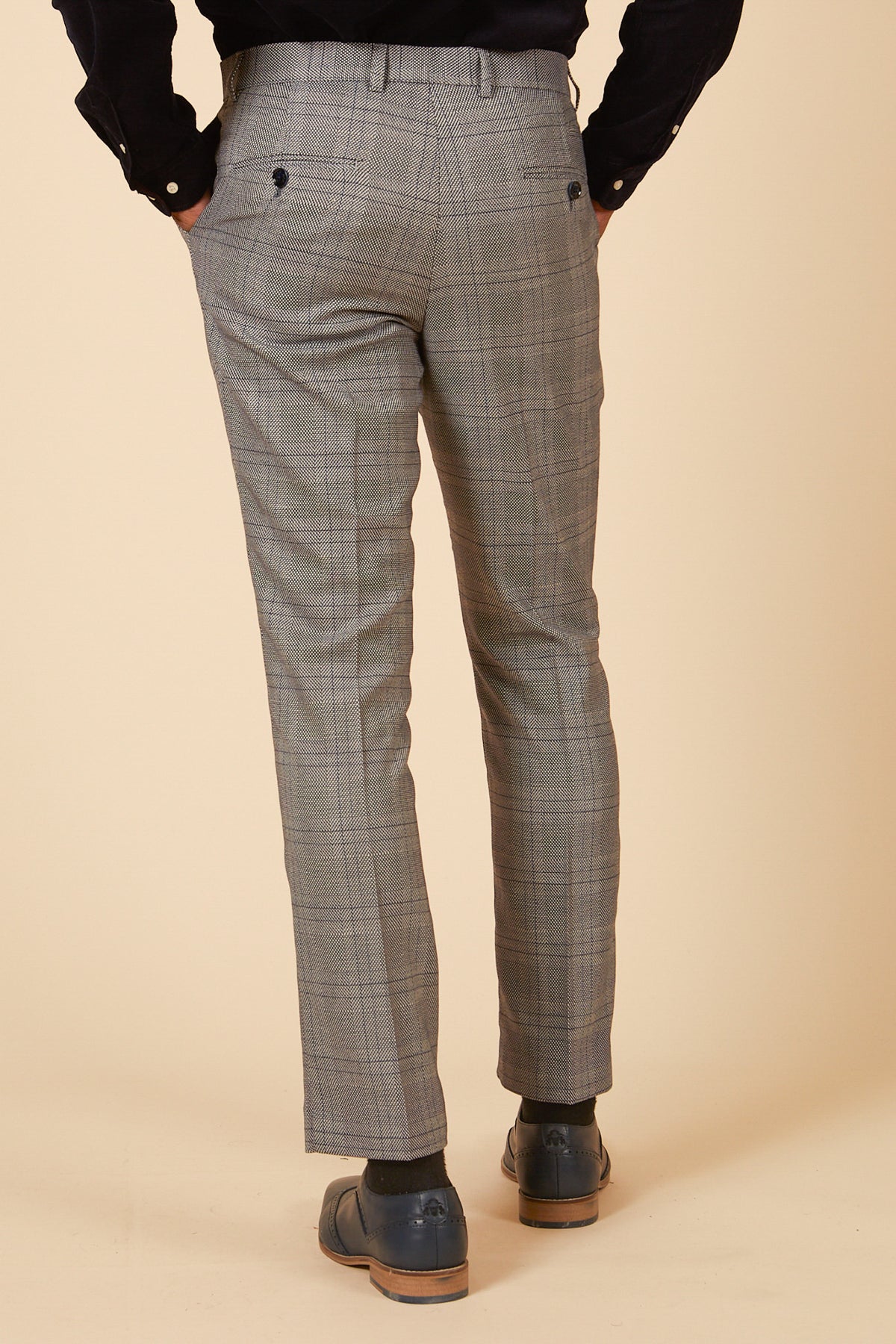 Man wearing the marcdarcy JERRY Grey Check Suit with Single Breasted Waistcoat and dark dress shoes, one hand in his pocket.