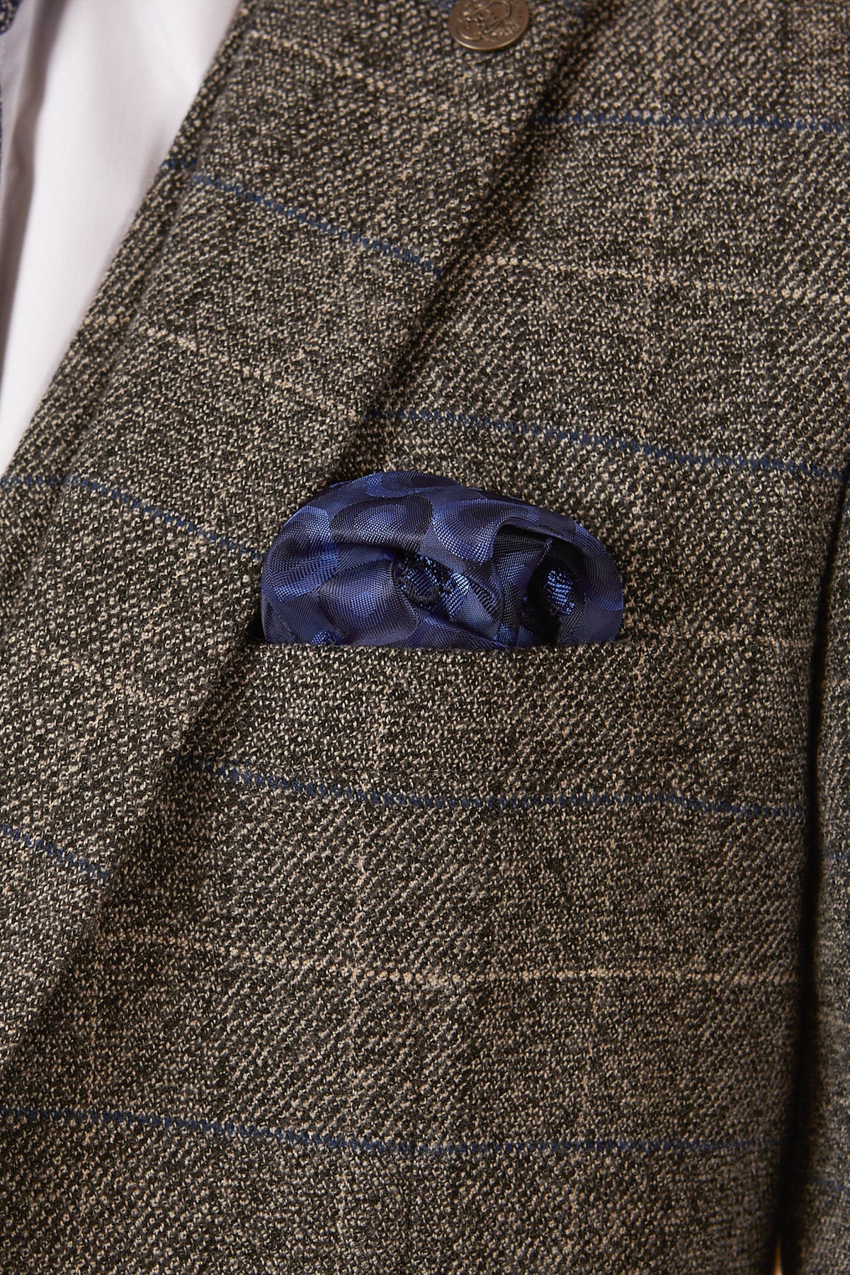 A close-up of the marcdarcy SCOTT - Grey Tweed Check Blazer, styled with a blue patterned pocket square in the breast pocket and a crisp white dress shirt underneath.