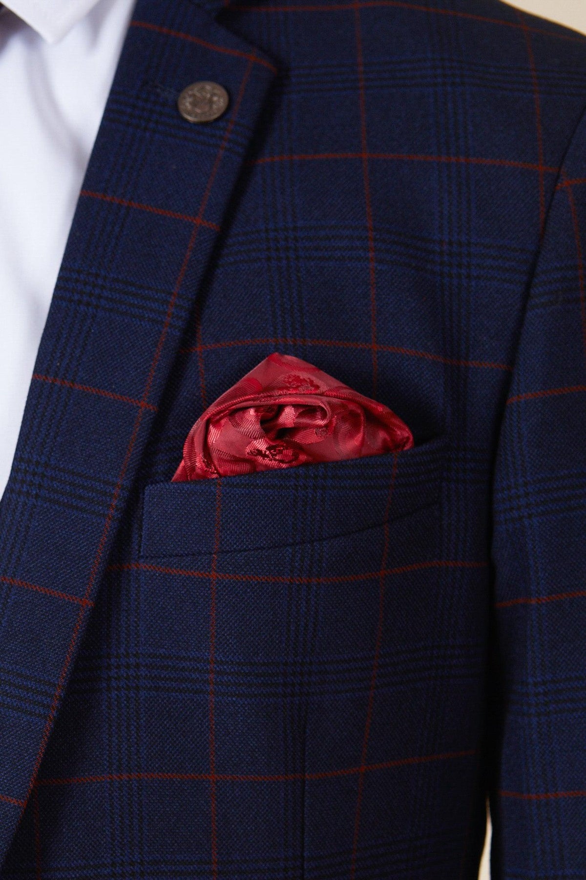 A close-up of a person wearing the Marc Darcy EDINSON Navy Wine Check Two Piece Suit, featuring a red pocket square and a crisp white dress shirt.