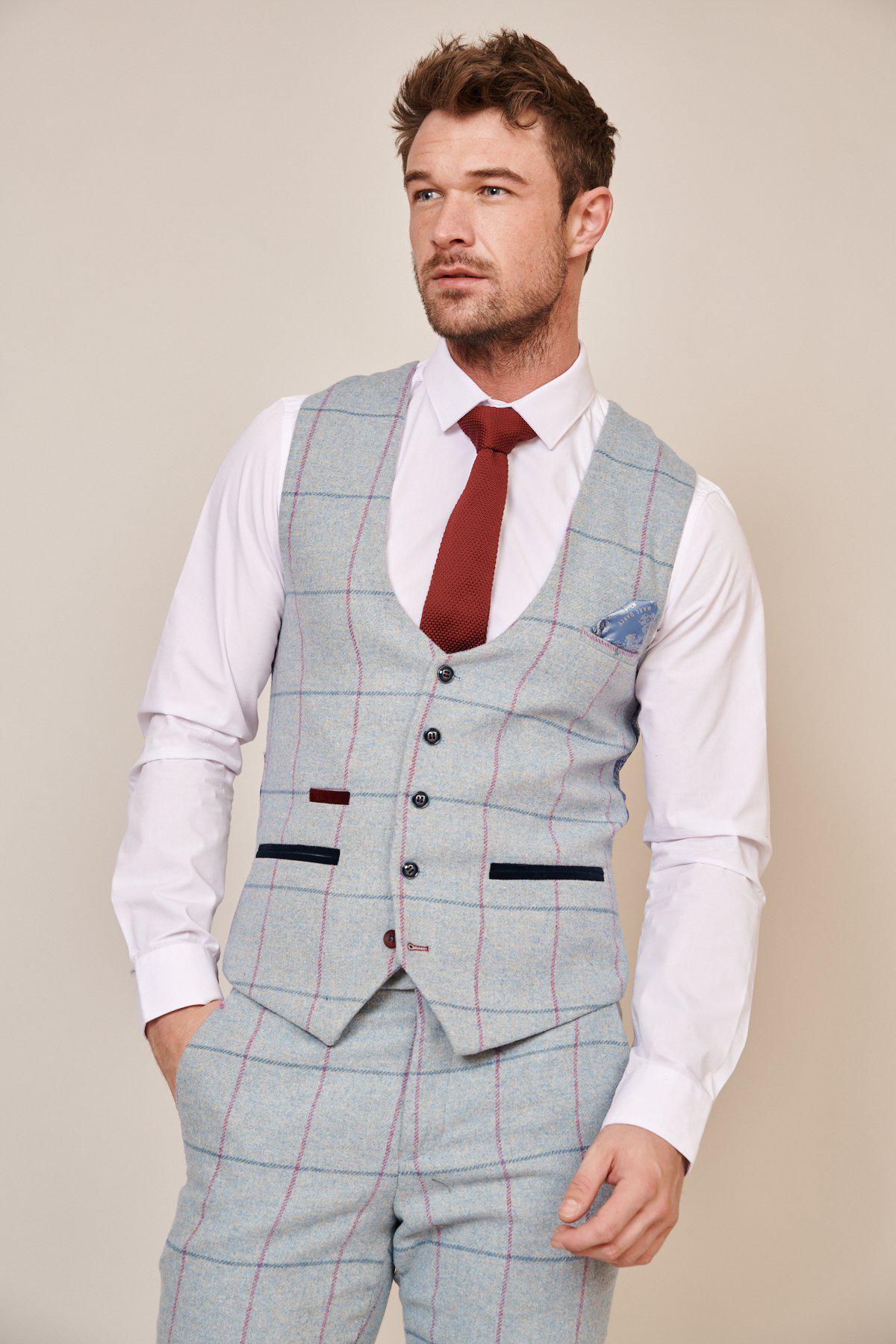 A man in a groom’s suit with a sky blue check, white shirt, red tie, and blue pocket square completes his look with the Marc Darcy NICOLAS - Sky Tweed Check Waistcoat.