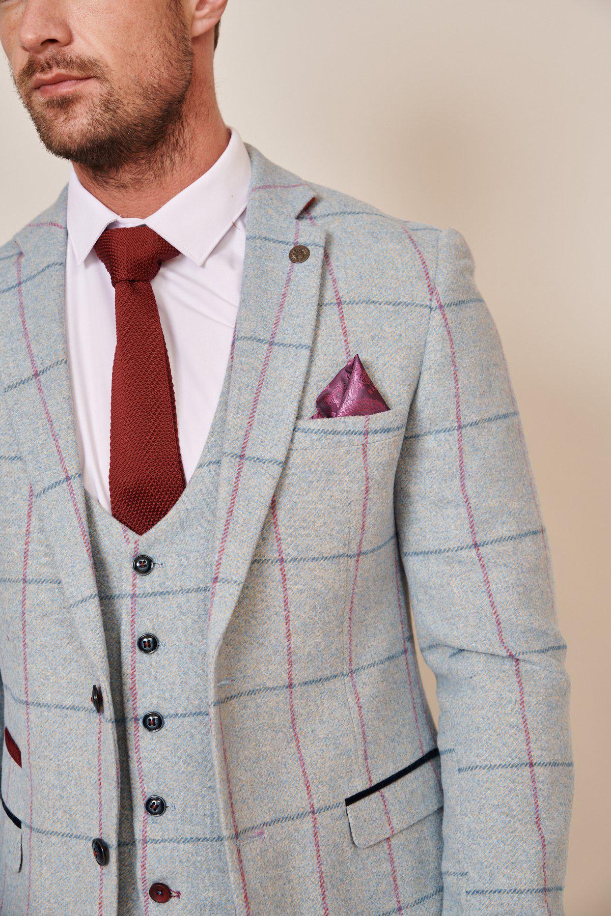 A man wears the Marc Darcy NICOLAS - Sky Check Tweed Blazer, paired with a white shirt, textured red tie, and purple pocket square. The cropped image shows him from shoulders to mid-torso.