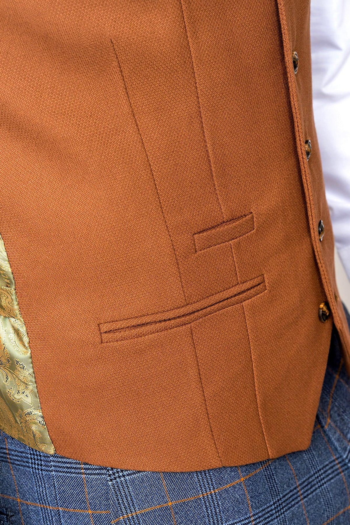 Close-up of a person wearing the marcdarcy JENSON Sky Blue Check Suit with Kelvin Tan Waistcoat, featuring decorative gold lining, buttons, welt pockets, and a peek of a white shirt sleeve for a mix-and-match style.