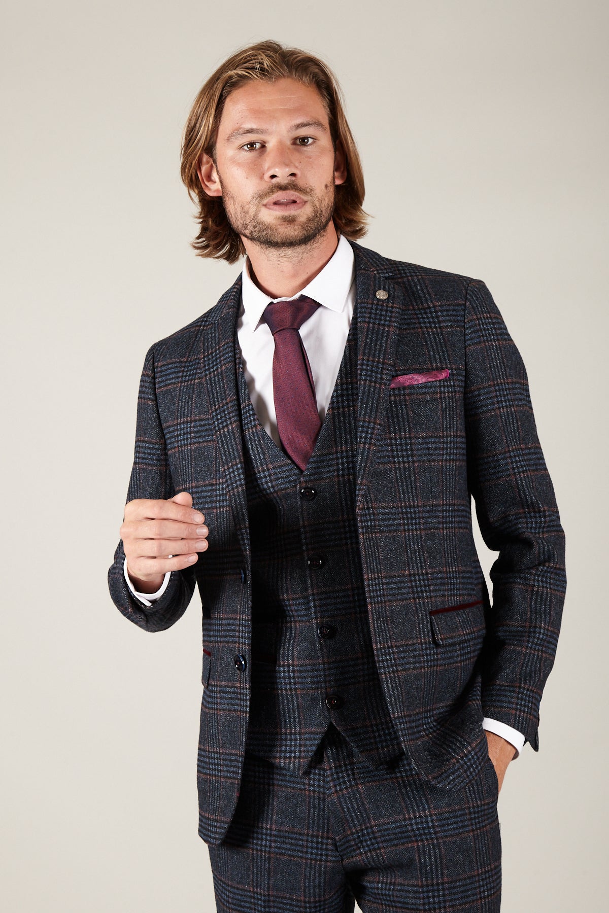 A man wearing the marcdarcy LUCA Navy Check Tweed Blazer in a slim fit, styled as part of a three-piece suit with a burgundy tie and pocket square.