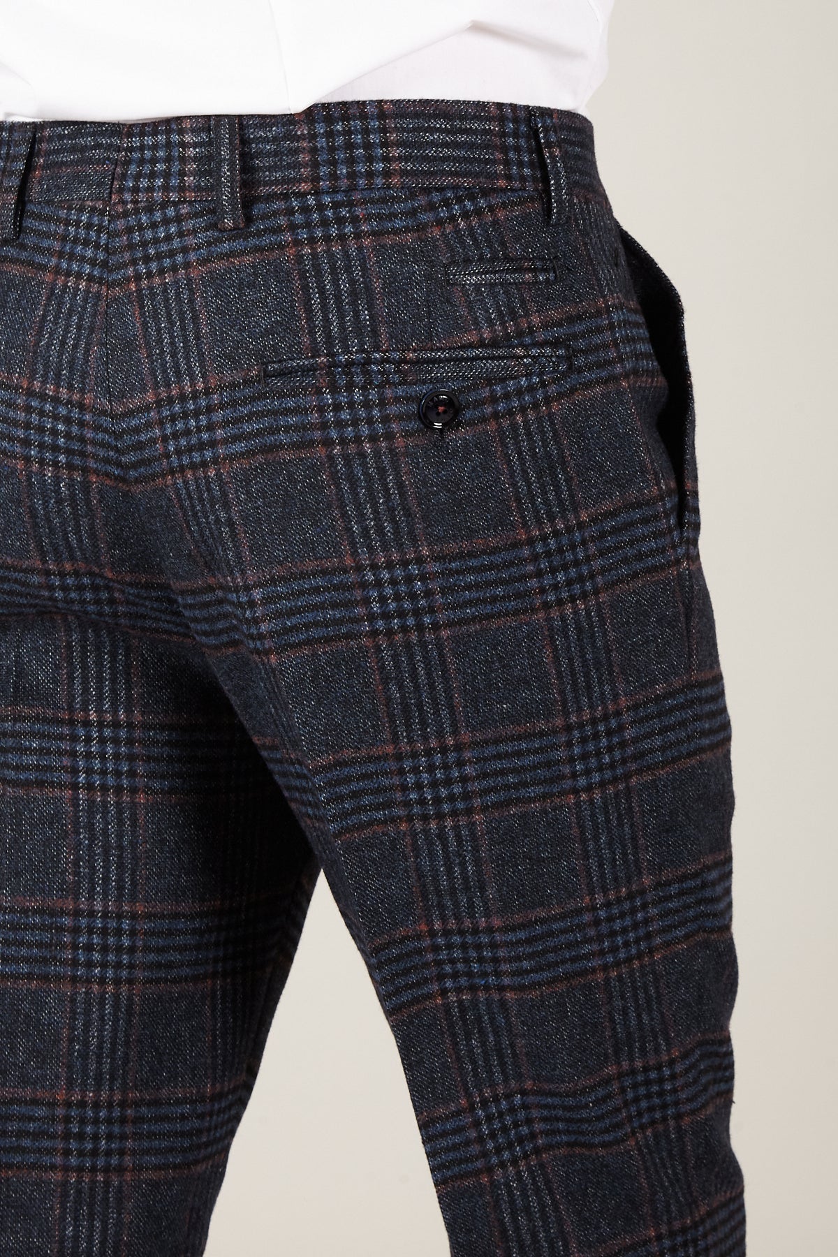 Close-up of marcdarcy’s LUCA Navy Check Tweed Trousers in a slim fit, featuring blue and brown lines, premium wool-blend fabric, and a single buttoned back pocket.