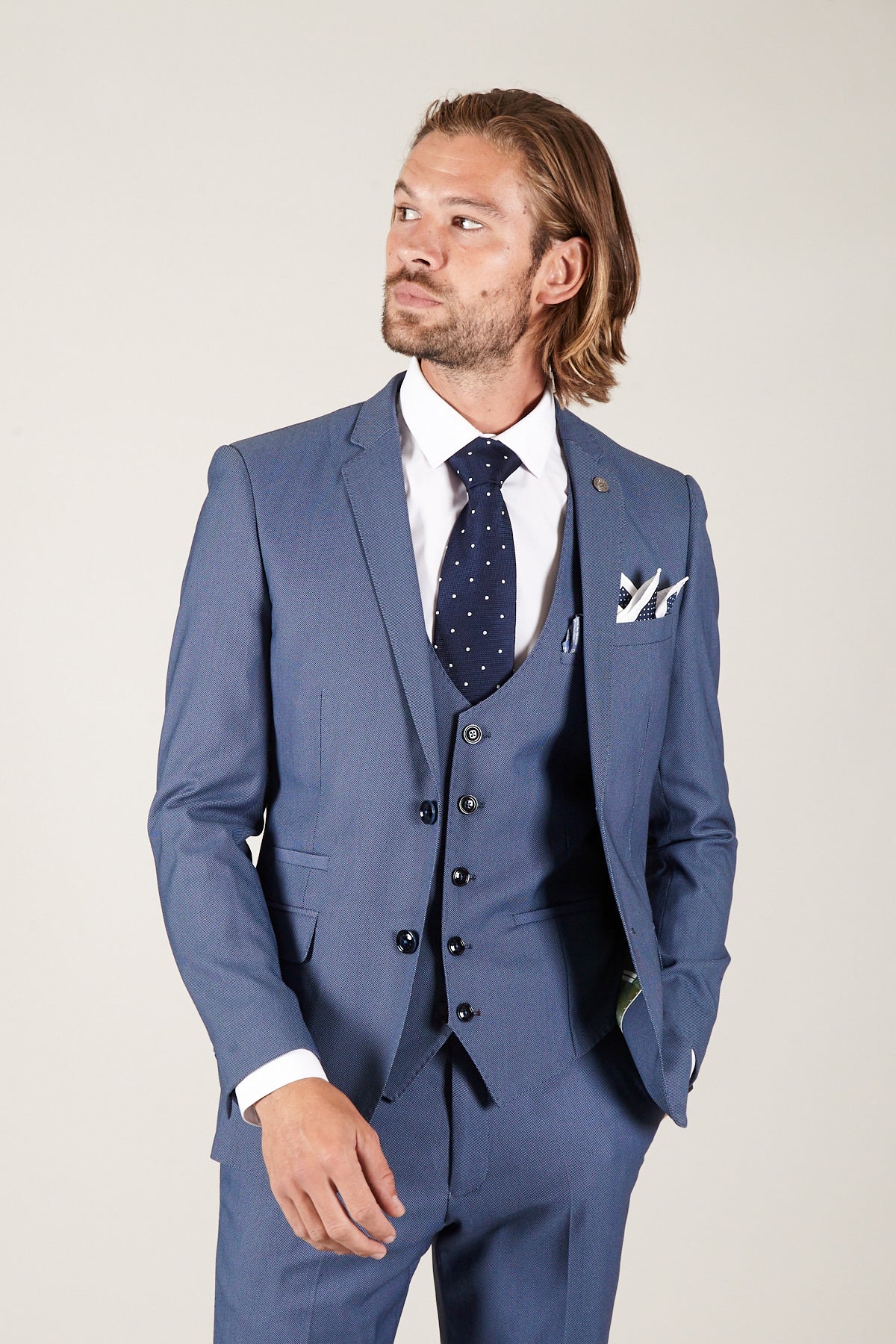 A man wears the Marc Darcy DANNY - Sky Tailored Blazer as part of a three-piece suit, paired with a white shirt, navy polka dot tie, and coordinating pocket square.