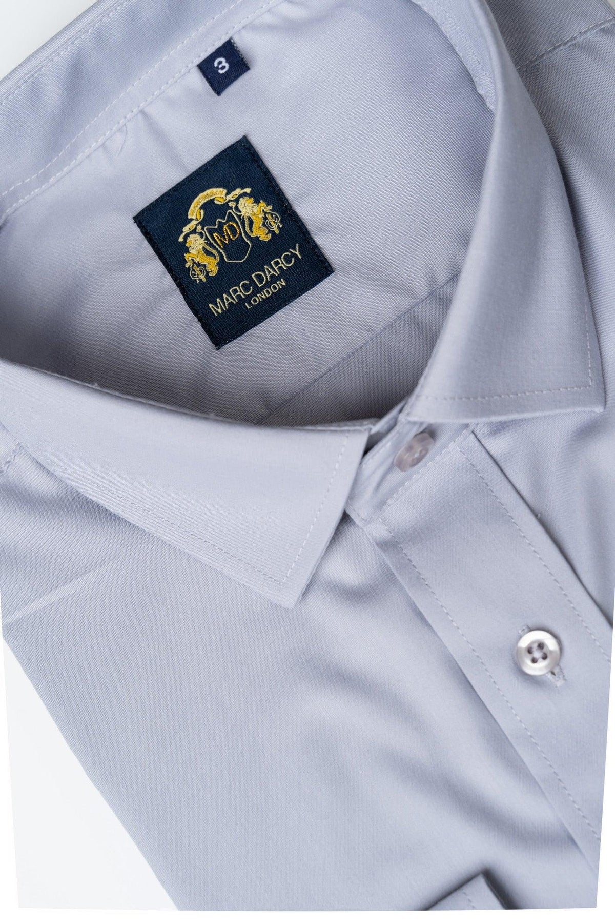 The CARTER - Silver Long Sleeve Shirt by Marc Darcy is a classic fit men's shirt with a visible collar, buttons, and a dark blue Marc Darcy label stitched inside the neckline.
