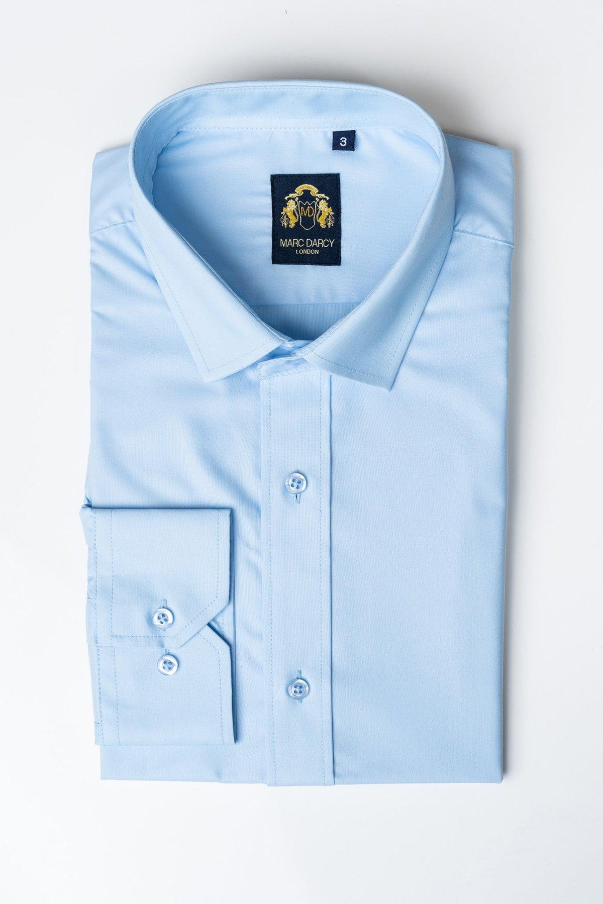 A folded CARTER Sky Long Sleeve Shirt by Marc Darcy, featuring a spread collar, logo tag, and size 3 label on the collar.