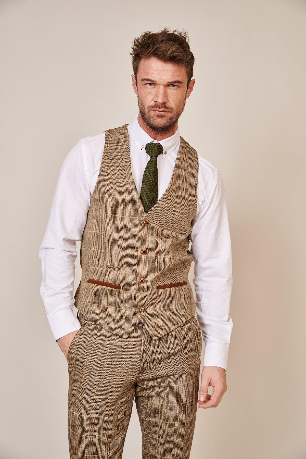 Former Everton midfielder Peter Reid & football manager Sam Allardyce wear marcdarcy's Max Navy Suit with the Ted waistcoat, standing against a neutral background and looking at the camera, one hand in a pocket.