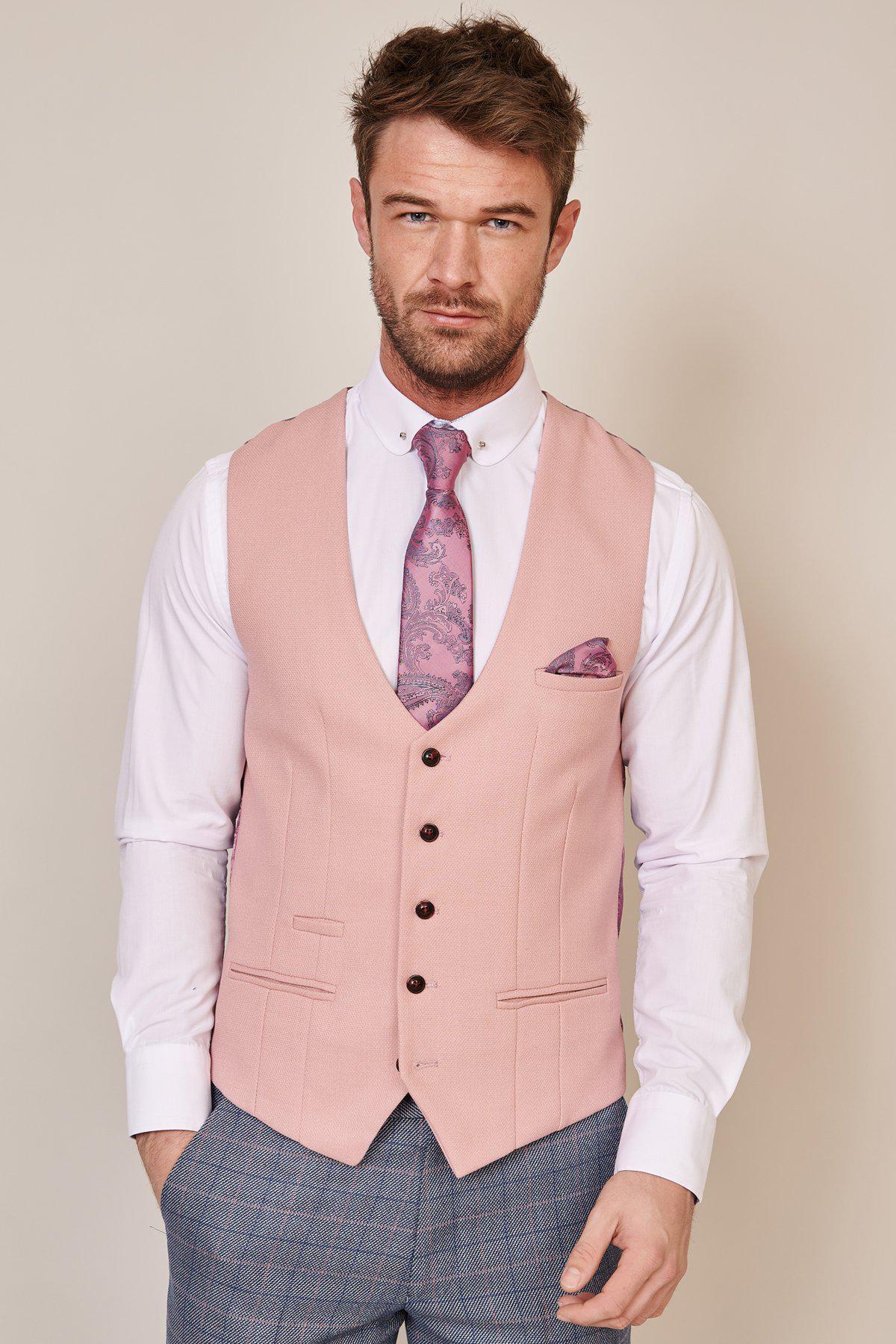 A man wearing the marcdarcy DION blue tweed check suit with a Kelvin pink waistcoat showcases stylish mix-and-match wedding attire.
