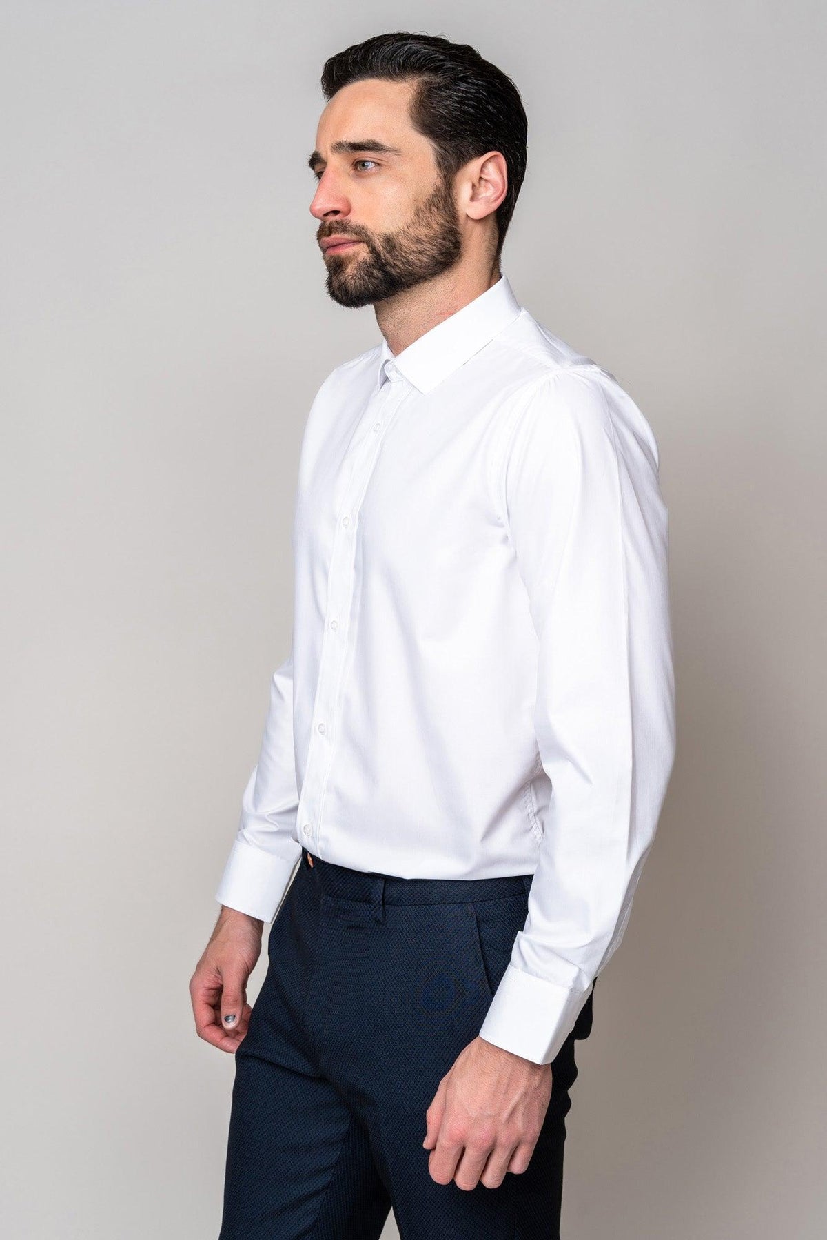 Man wearing the Marc Darcy CARTER White Long Sleeve Shirt and navy textured pants, profile view—a classic men’s wardrobe staple.