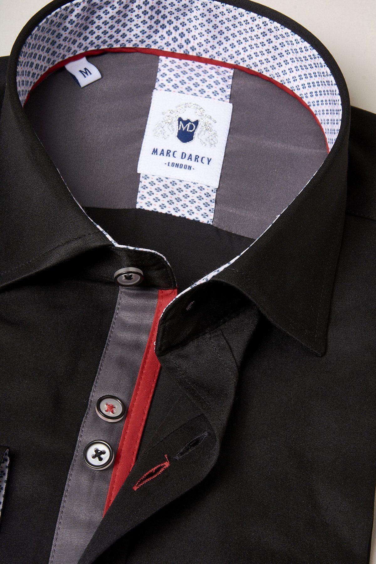 A close-up of the ALFIE black long sleeve shirt by Marc Darcy, featuring a spread collar, grey and red trim, patterned inner collar, contrasting buttons, and visible brand label—ideal for a sharp, polished style.