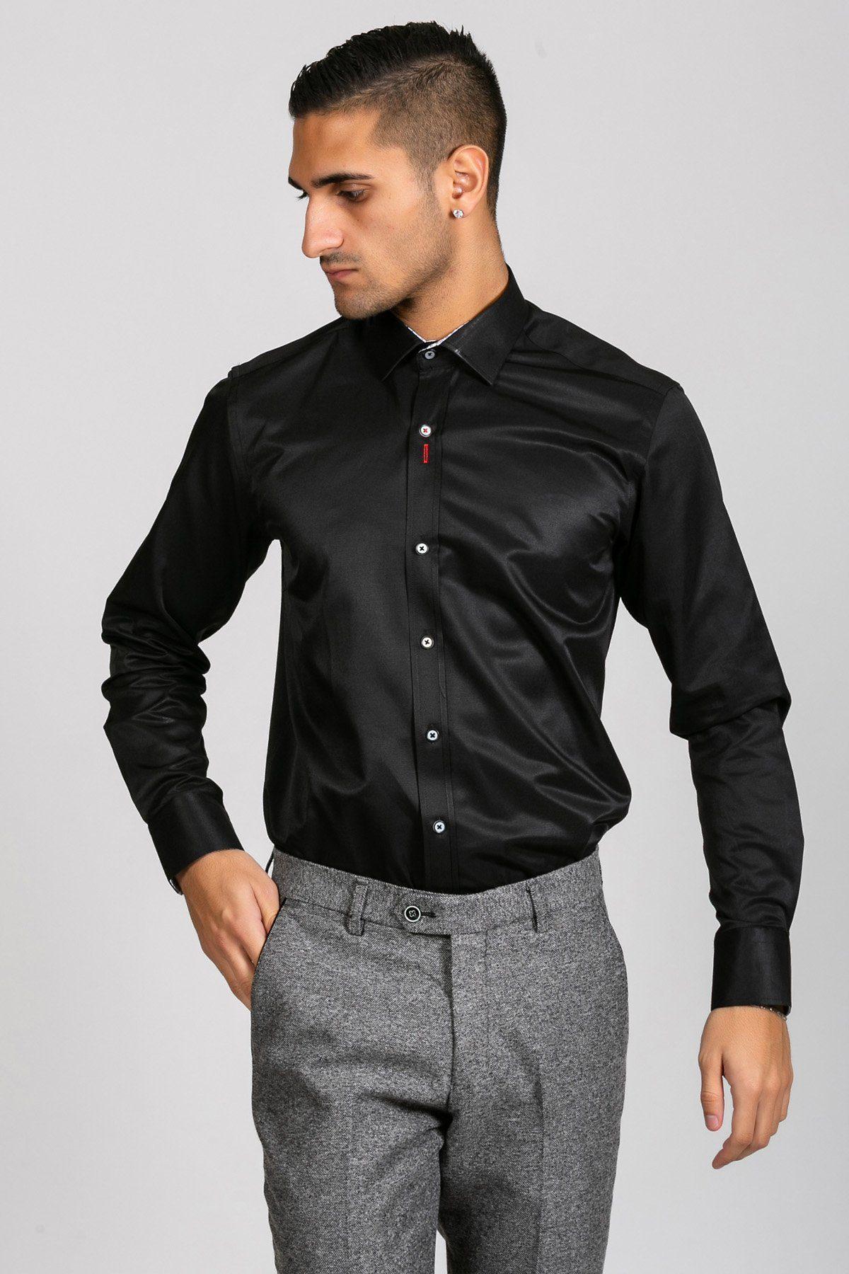 A man stands with one hand in his pocket, looking to the side in a Marc Darcy ALFIE Black Long Sleeve Shirt and gray dress pants against a plain light background for a polished look.