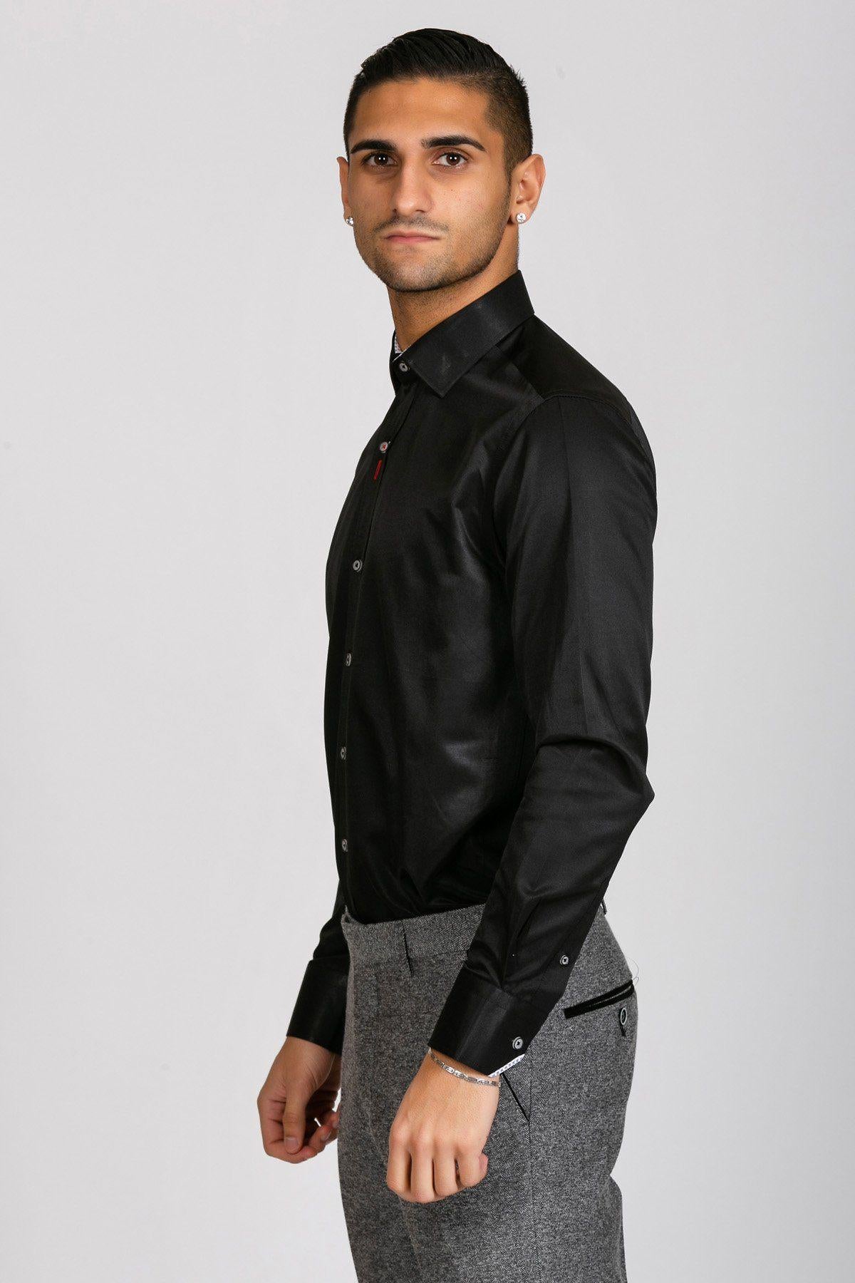 A man with short dark hair models the Marc Darcy ALFIE Black Long Sleeve Shirt, styled with gray trousers, standing sideways and looking at the camera against a plain light background for a polished appearance.