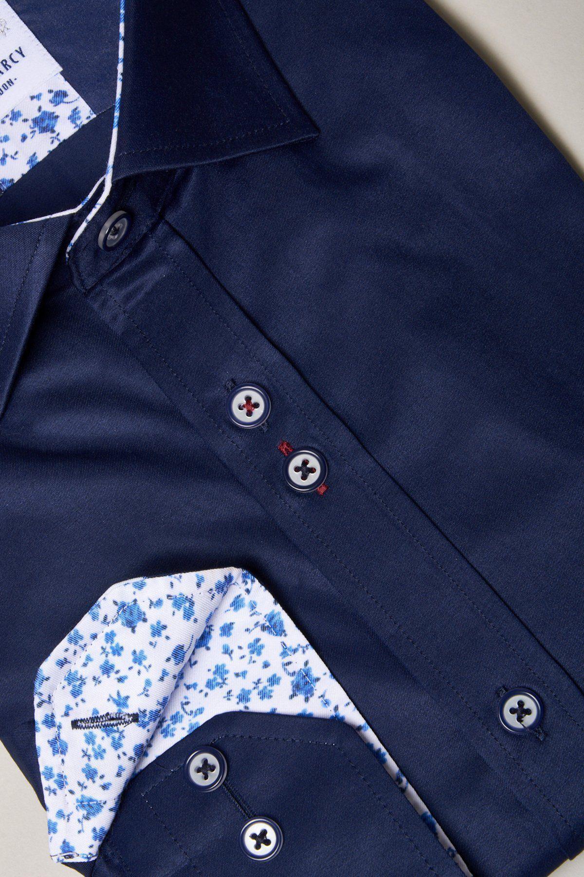 The Marc Darcy ALFIE Navy Long Sleeve Shirt features a folded design, white and blue floral inner collar and cuffs, dark buttons, and bold contrast detailing by the buttonholes.