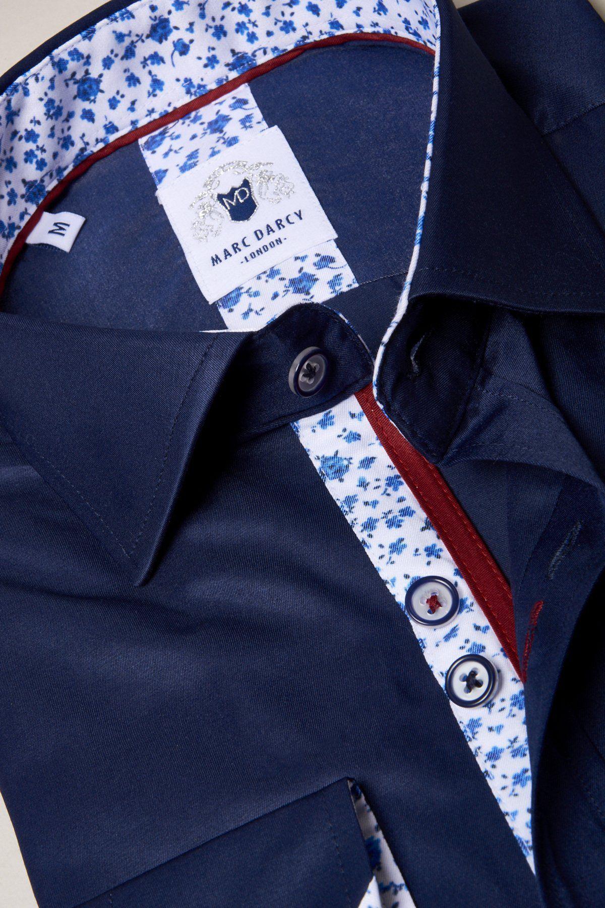 The ALFIE Navy Long Sleeve Shirt by Marc Darcy features a sheen finish, floral-patterned inner collar and button placket, plus navy and white buttons.