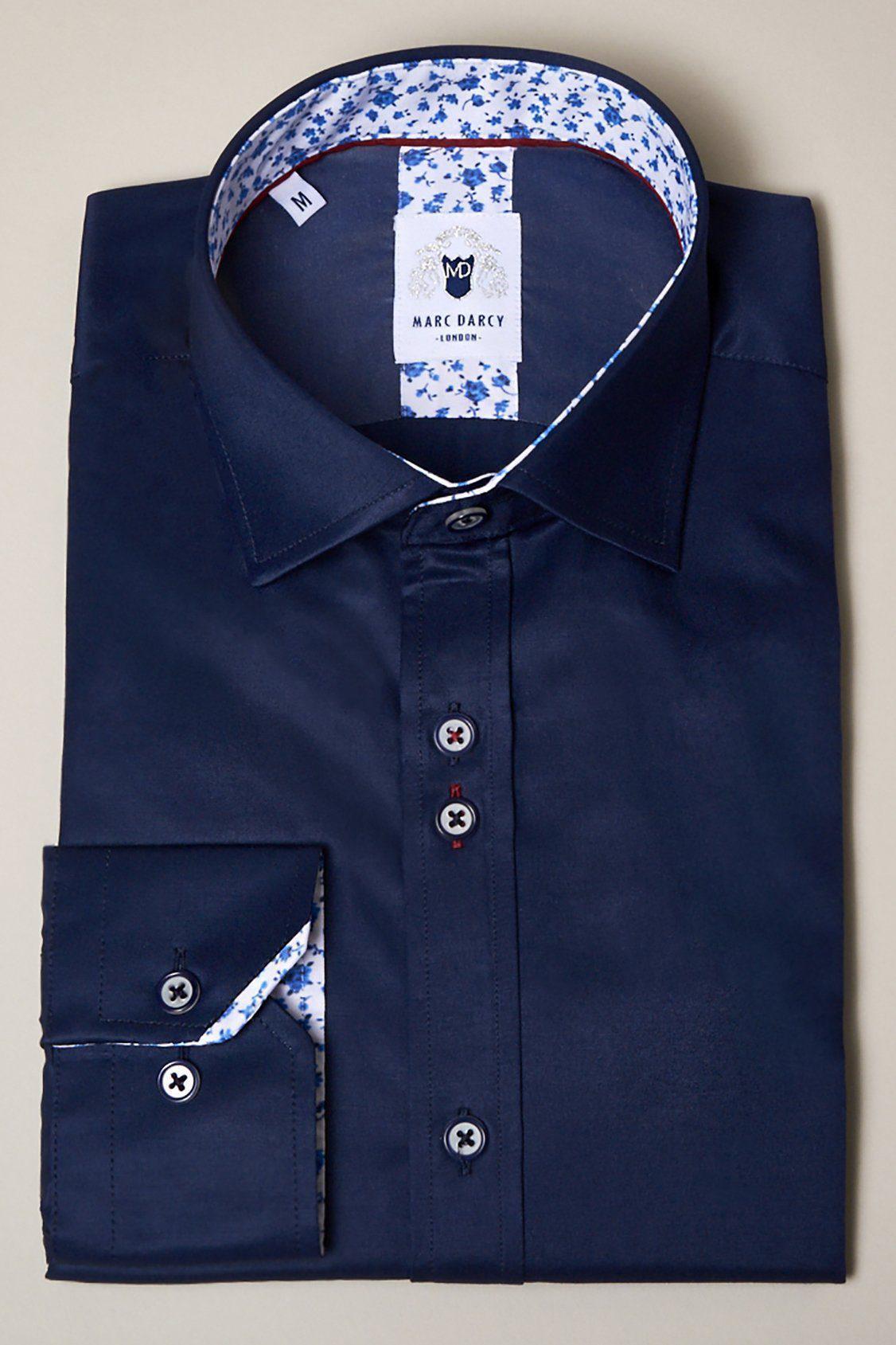The ALFIE Navy Long Sleeve Shirt by Marc Darcy features a dark blue design, floral trim on the collar and cuffs, dark buttons, and a visible Marc Darcy label inside the collar.