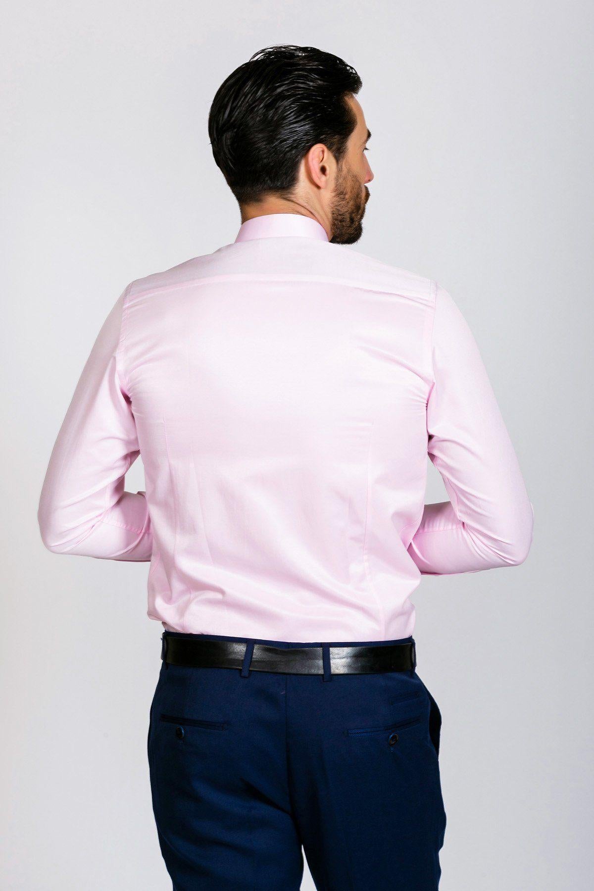 Back view of a man wearing the ALFIE Pink Long Sleeve Shirt by Marc Darcy, paired with navy blue pants and a black belt.