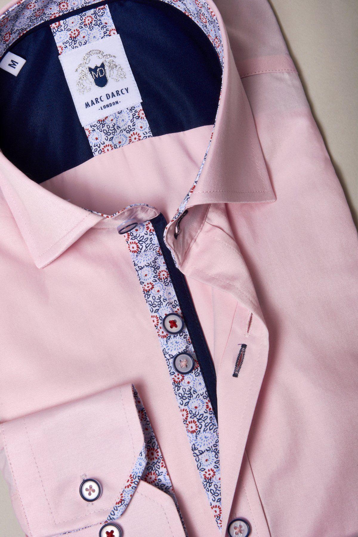 The ALFIE Pink Long Sleeve Shirt by Marc Darcy, in a classic fit, has striking floral accents on the inner collar and placket, plus blue and red buttons. Its neatly displayed on a light surface.