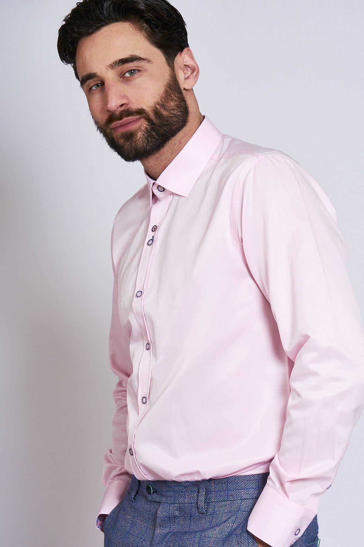 A man with dark hair and a beard wears the Marc Darcy ALFIE pink long sleeve shirt and blue tweed pants.
