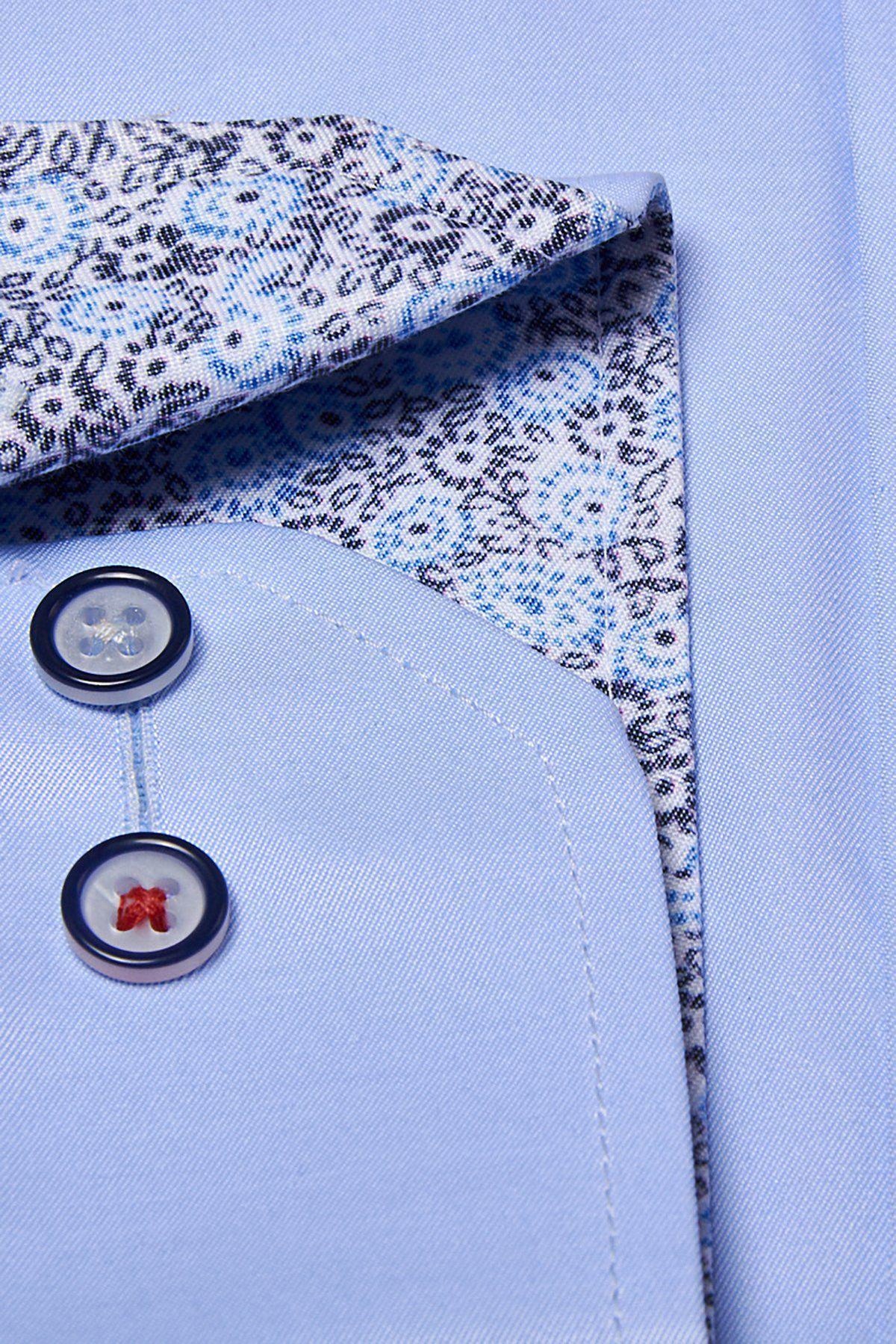Close-up of the Marc Darcy ALFIE Sky Blue Long Sleeve Shirt, classic fit, with a pocket featuring two dark-edged buttons and an inner collar detailed with blue and black floral pattern.