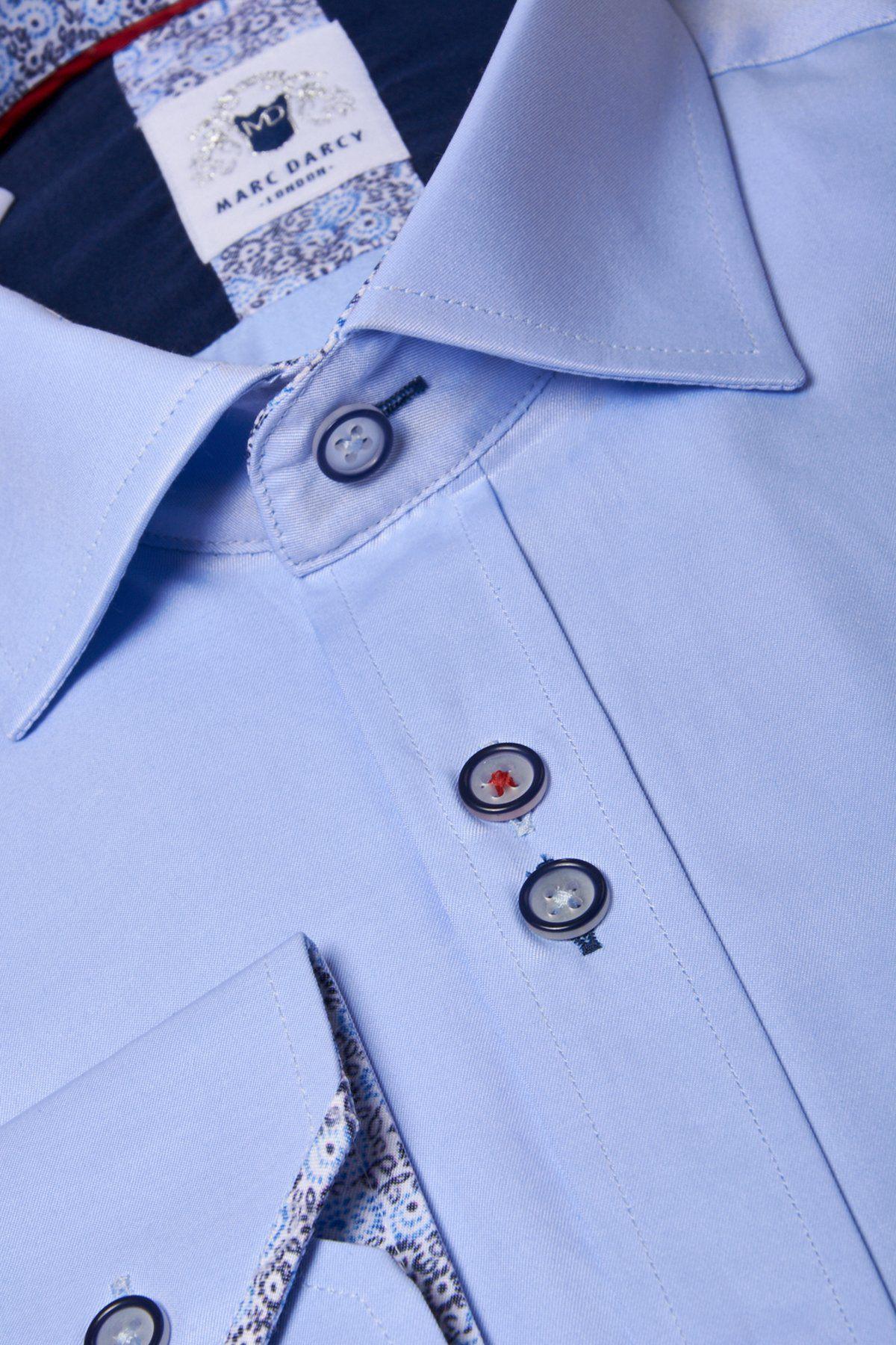 Close-up of the Marc Darcy ALFIE Sky Blue Long Sleeve Shirt, featuring dark blue buttons, contrast white stitching, a patterned inner collar, and a pocket flap—ideal for adding style to your office look.