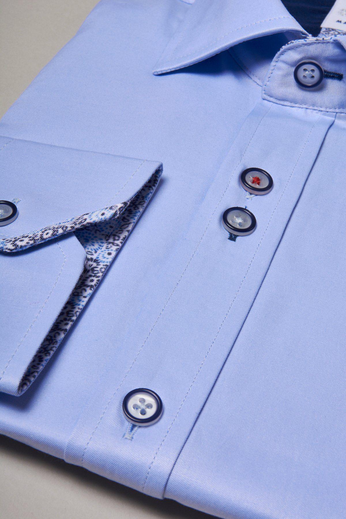 Close-up of the Marc Darcy ALFIE Sky Blue Long Sleeve Shirt in a soft cotton blend, featuring patterned fabric at the cuff and buttons with dark rims and white centers—ideal for refined office style.