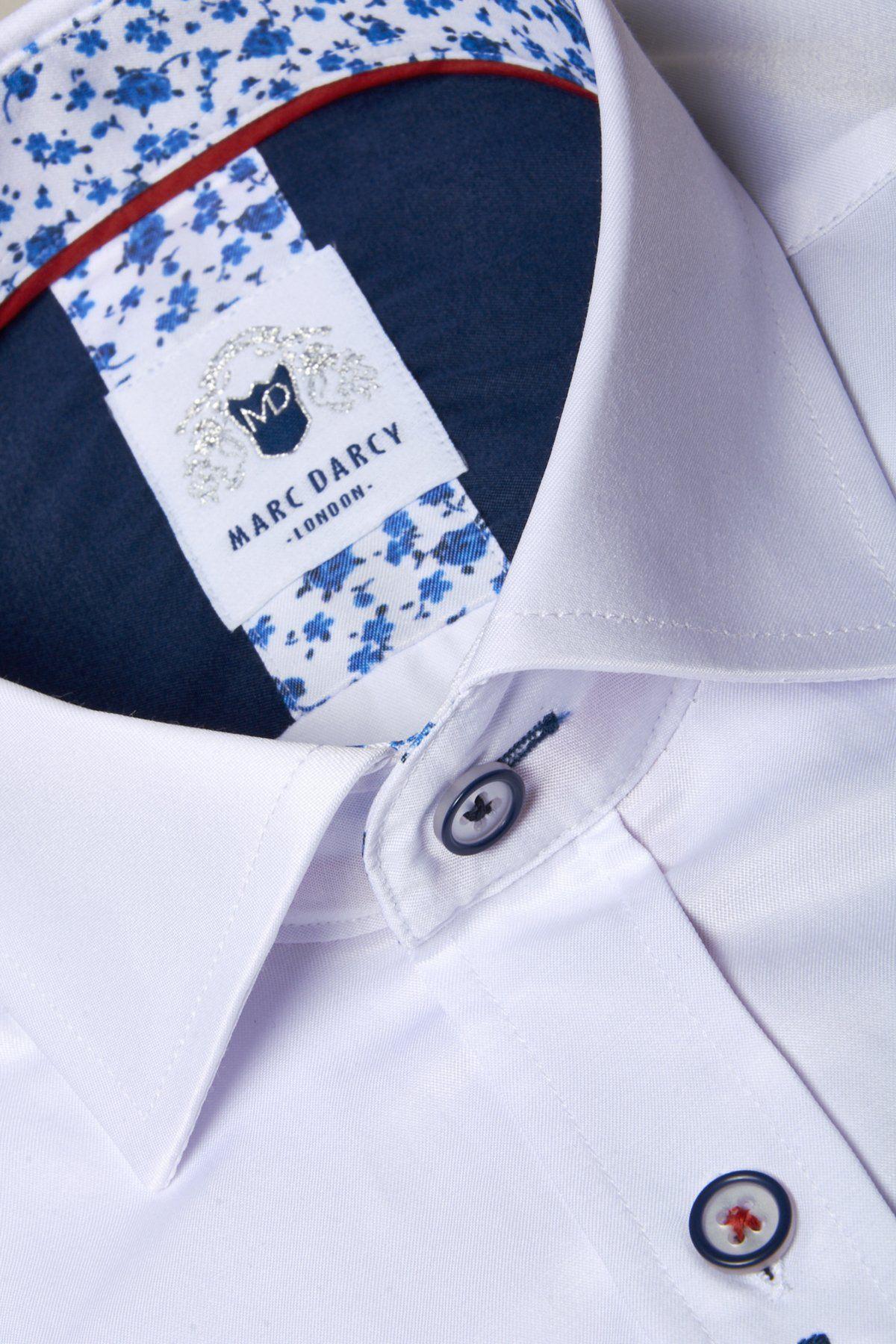 Close-up of the ALFIE White Long Sleeve Shirt by Marc Darcy, made from a cotton blend and featuring navy blue floral detailing inside the collar.