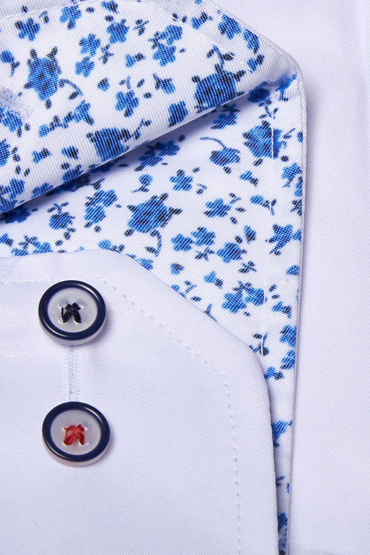 Close-up of the Marc Darcy ALFIE white long sleeve shirt in cotton blend, featuring a blue floral print collar and two dark-rimmed buttons—one stitched with black thread, the other with red.