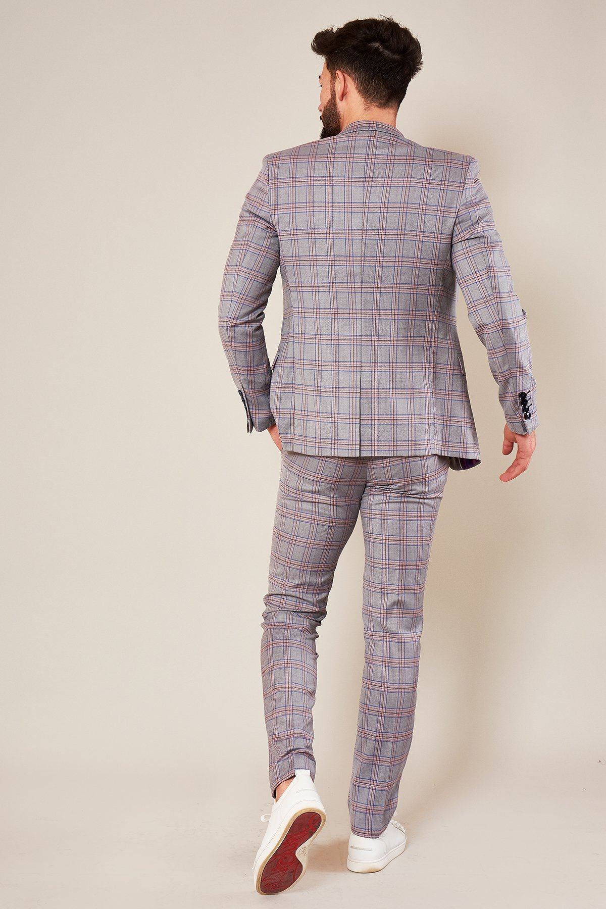 Rear view of a man wearing the Marc Darcy ALVIN - Grey Pink Check Blazer and white sneakers against a neutral background.