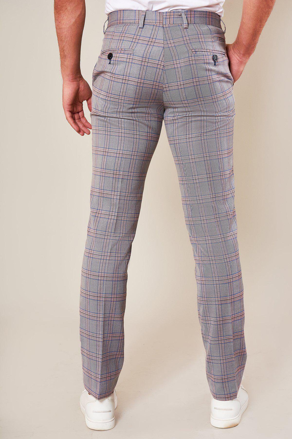 A person is seen from the back wearing Marc Darcys ALVIN - Grey Pink Check Trousers, paired with white sneakers and a white shirt, standing against a neutral background.