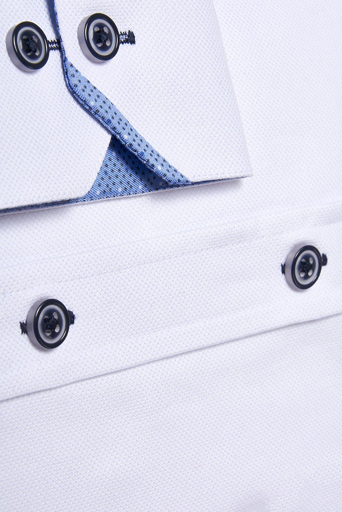 Close-up of the Marc Darcy ARCHIE white grandad collar shirt, featuring navy buttons and blue inner collar lining. Oxford weave fabric texture and button stitching are clearly shown.