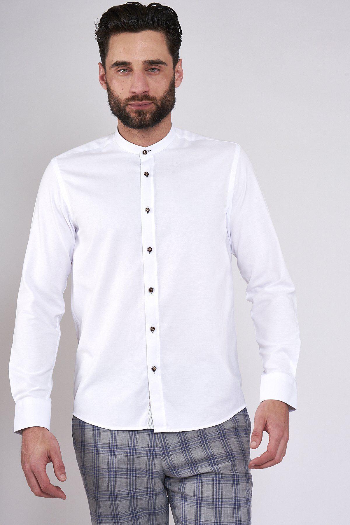 A man with short dark hair and a beard wears the ARCHIE white grandad collar shirt with tan buttons by Marc Darcy and gray plaid pants, standing against a plain light background for a casual vibe.