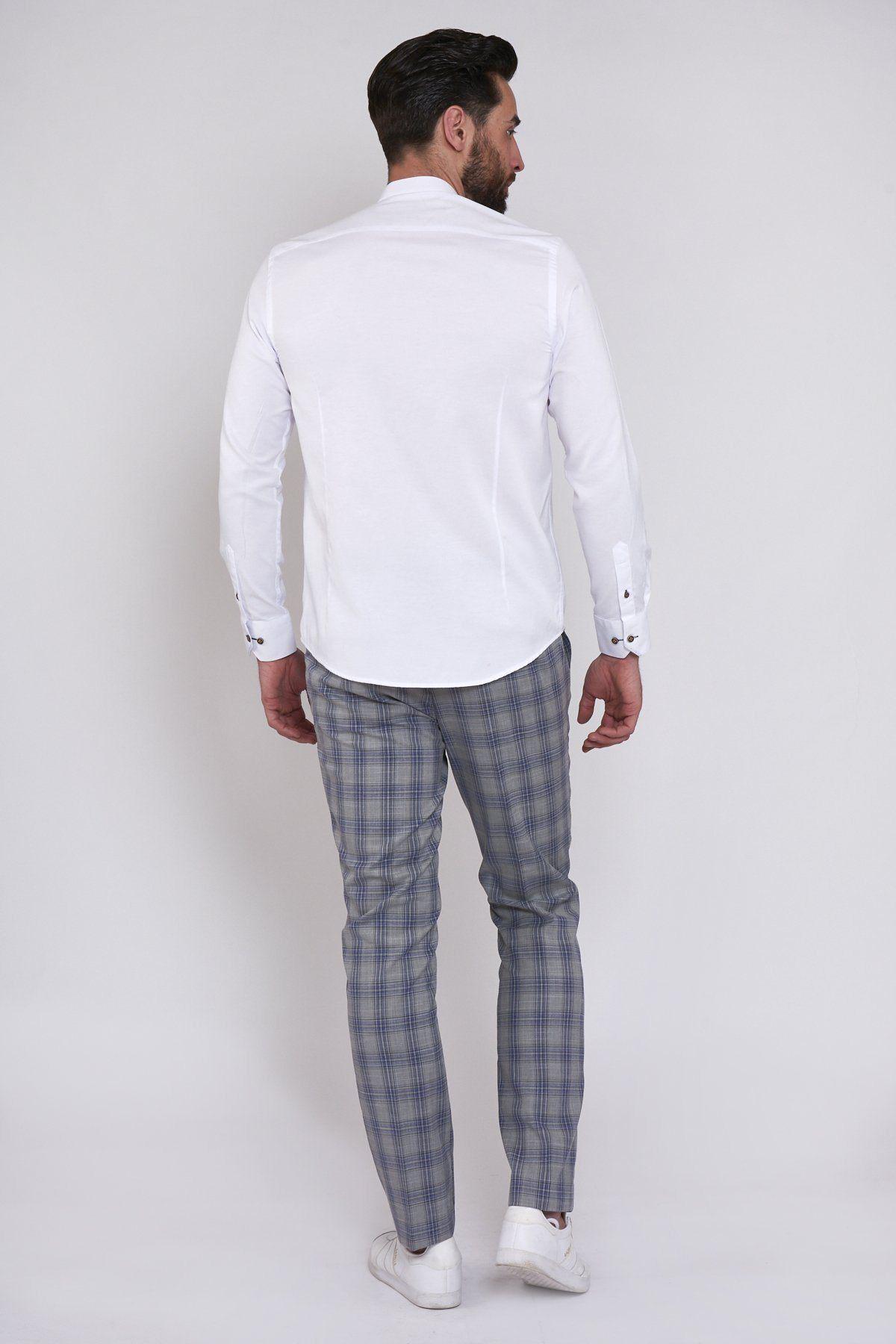 A man faces away from the camera, wearing the Marc Darcy ARCHIE white grandad collar shirt with tan buttons, gray plaid trousers, and white sneakers for a casual look against a plain light background.