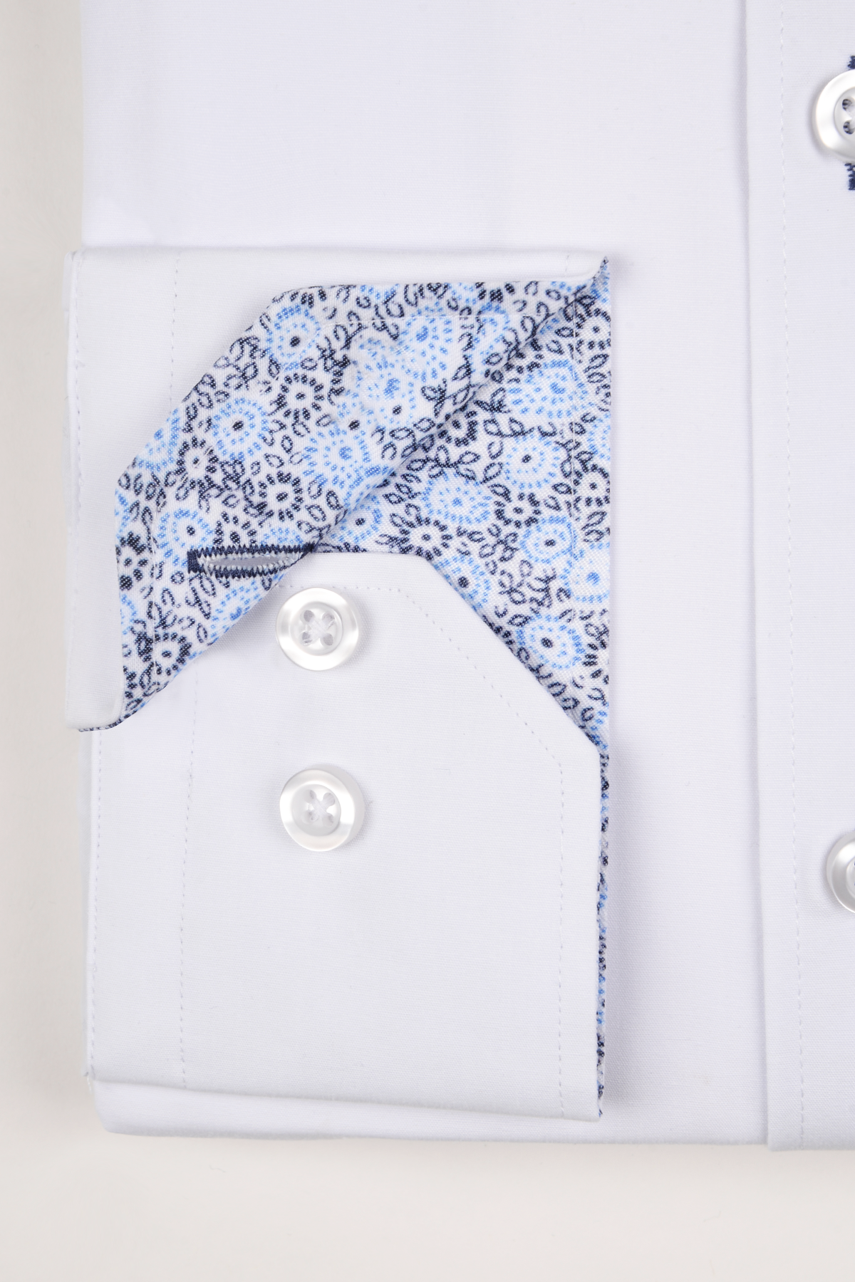 The BENSON White Penny Collar Shirt With Collar Bar by marcdarcy features a blue and black floral lining and two white buttons—perfect for enhancing your club or pinned collar shirt collection.