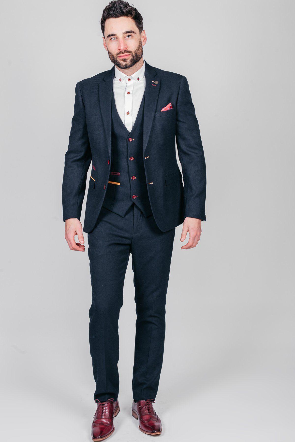 Nick Pope, Newcastle United and England goalkeeper, wears a JD4 Navy Suit by marcdarcy with a white patterned shirt and burgundy dress shoes—an ideal wedding guest look.
