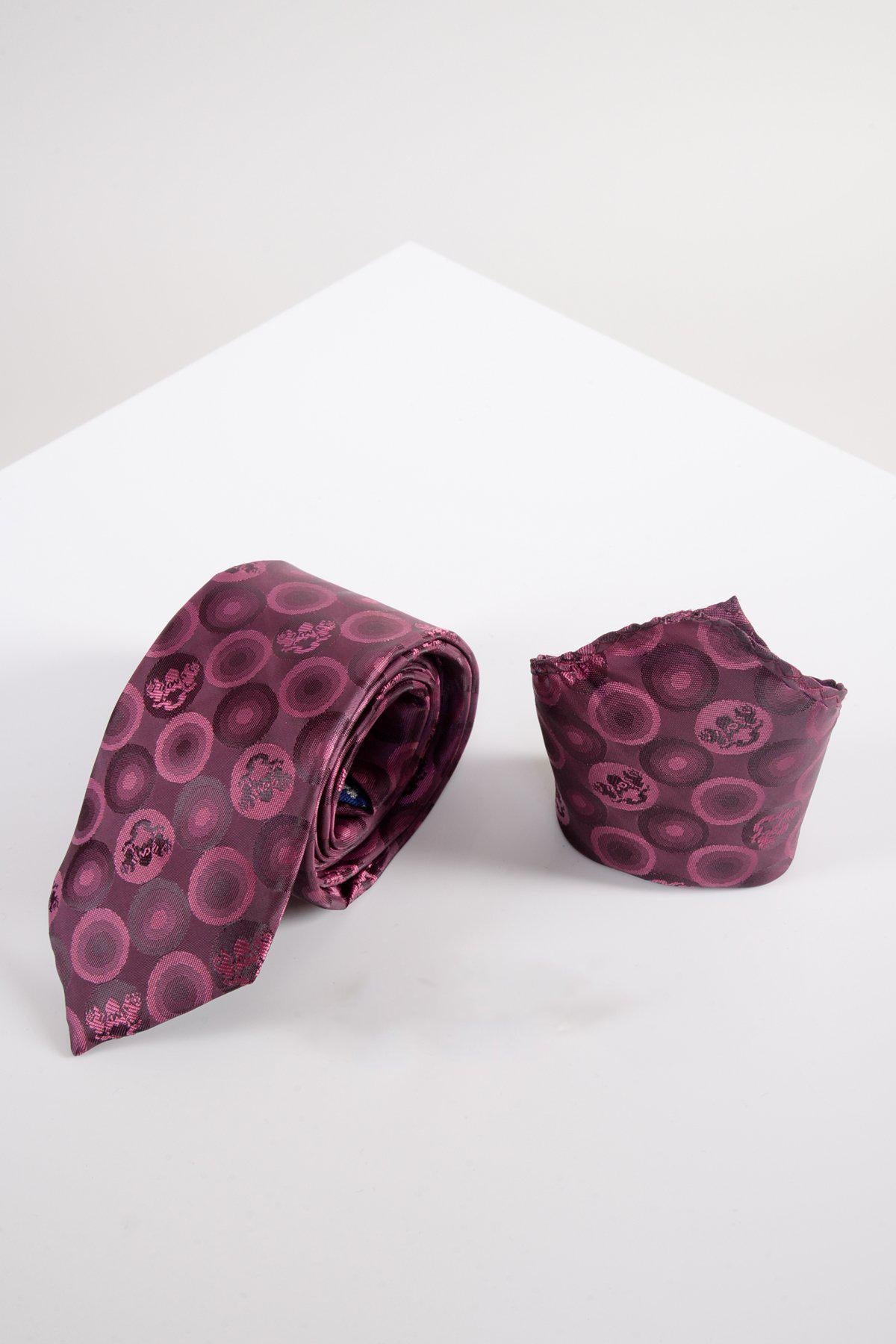 The Marc Darcy BUBBLES - Berry Bubble Circle Print Tie and Pocket Square Set features a maroon silk-style tie with pink and purple circles, rolled up beside the matching pocket square on a white surface with a minimal background.
