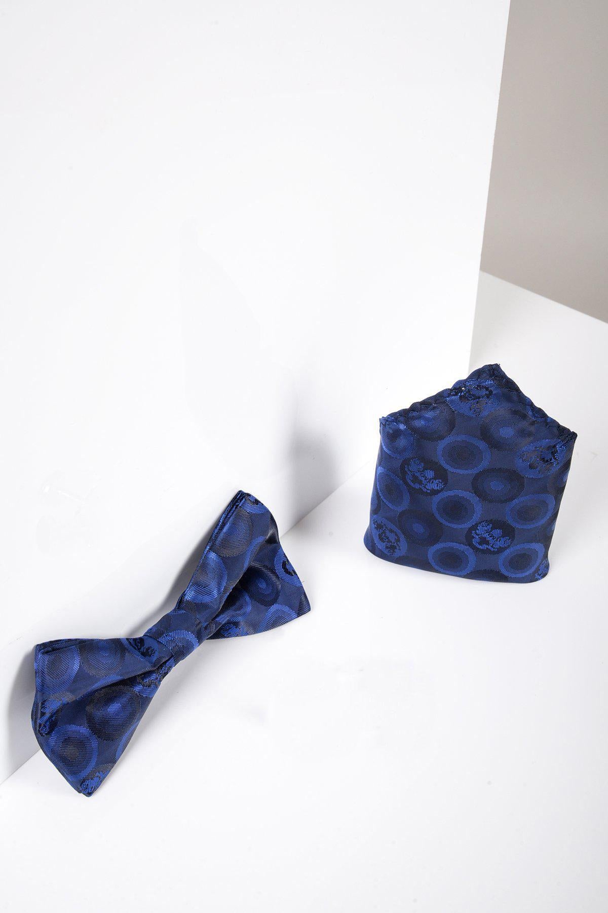 The BUBBLES - Navy Bubble Circle Print Bow Tie and Pocket Square Set by Marc Darcy is shown on a white surface with white and light gray walls in the background.
