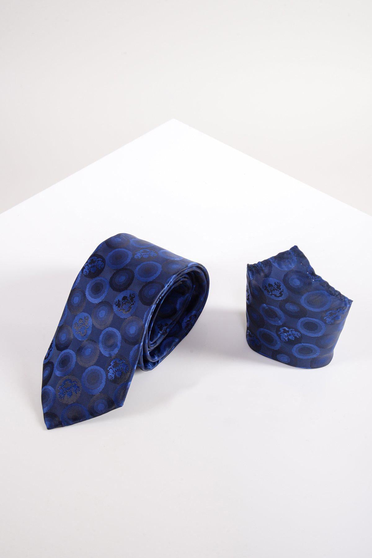 The Marc Darcy BUBBLES - Navy Bubble Circle Print Tie and Pocket Square Set is displayed on a white surface with a geometric background, giving any outfit a premium look.