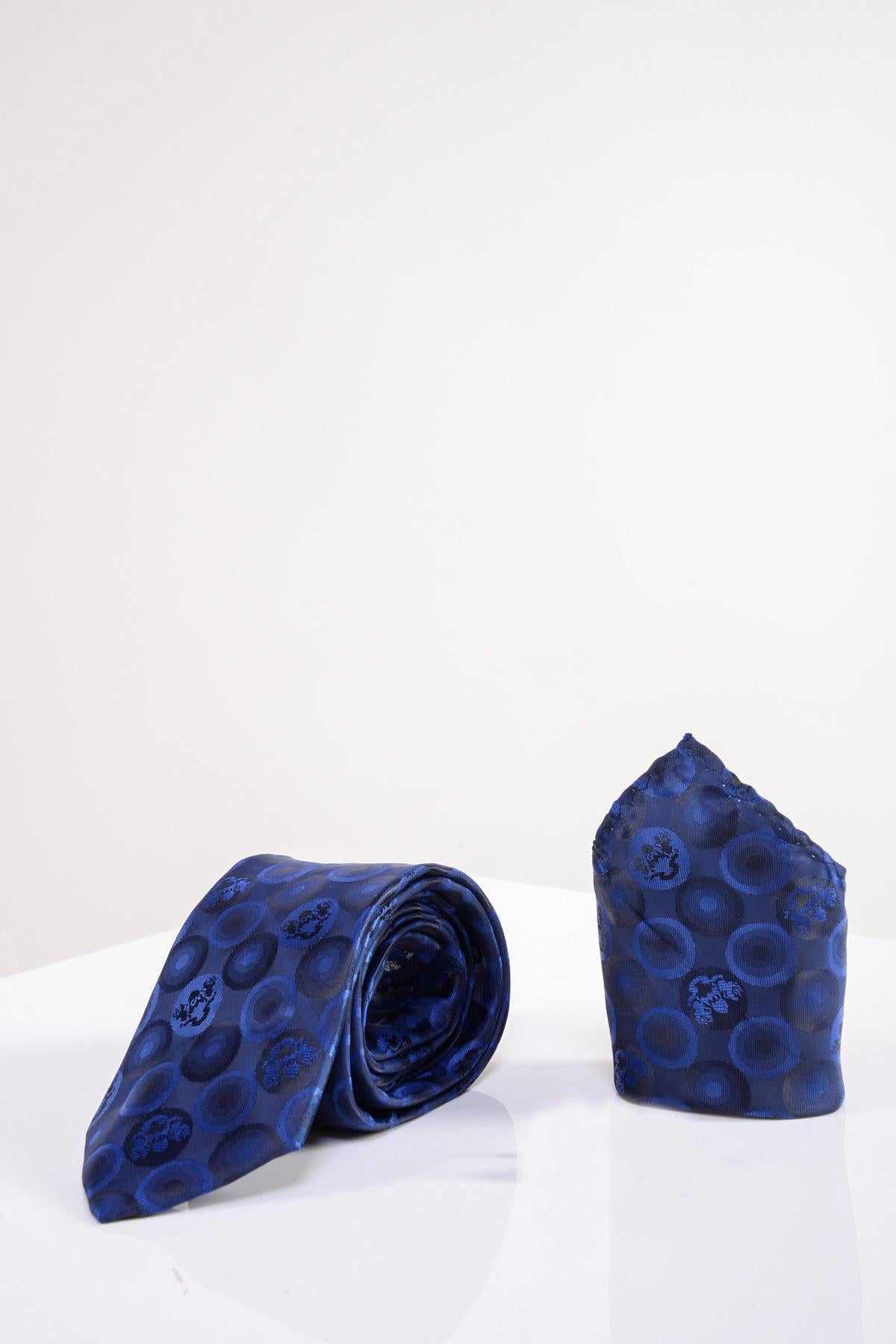 The BUBBLES - Navy Bubble Circle Print Tie and Pocket Square Set by Marc Darcy features a rolled navy tie and a folded blue pocket square with a bubble circle pattern, elegantly displayed on a white background.