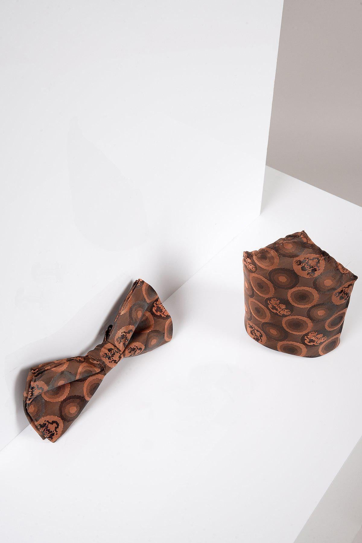The Marc Darcy BUBBLES Orange Brown Bubble Circle Print Bow Tie and Pocket Square Set is displayed on a white, angled surface against a neutral background.