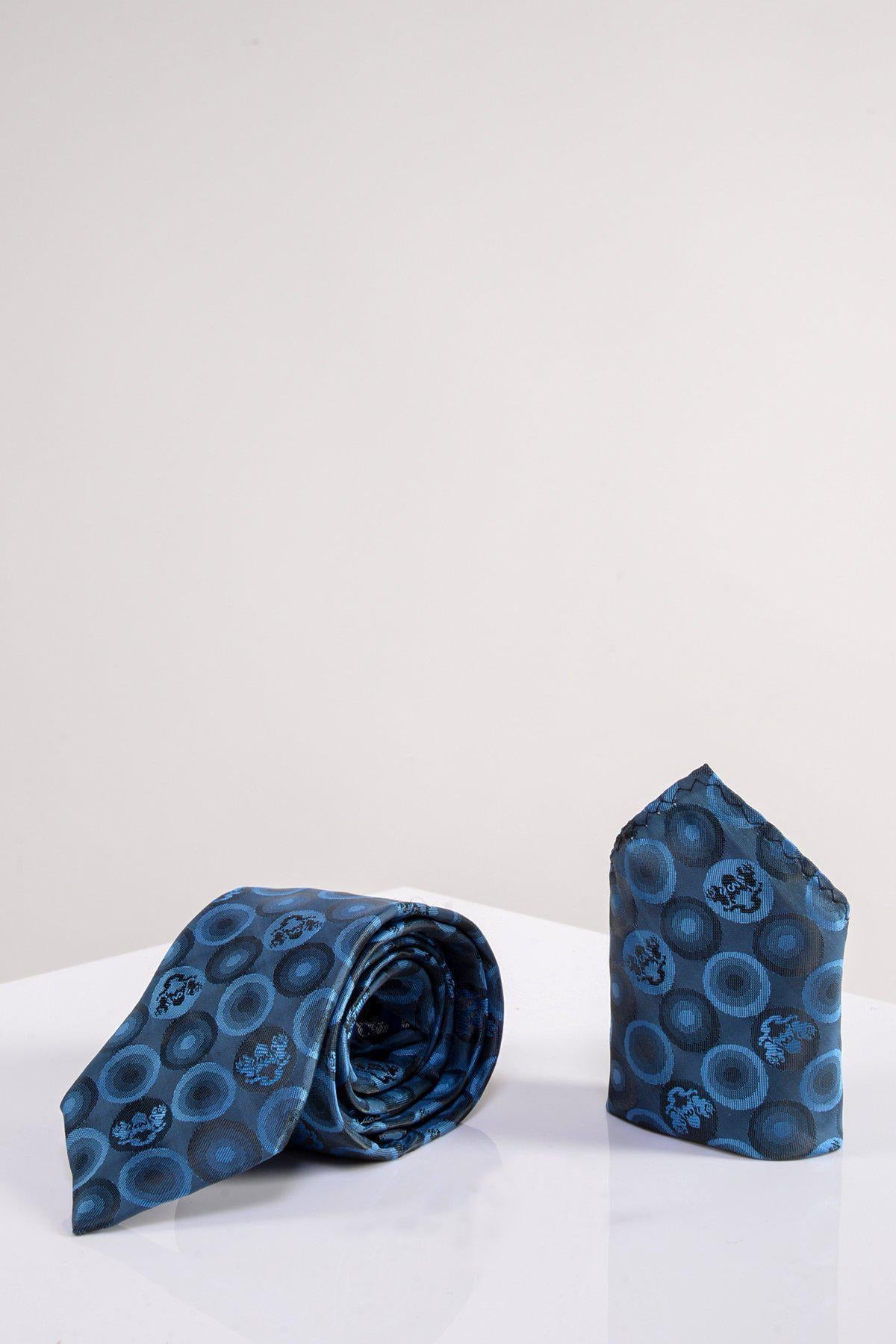 The Marc Darcy BUBBLES - Sky Teal Bubble Circle Print Tie and Pocket Square Set is displayed on a white surface, making it the perfect statement accessory to elevate men’s suits with its bold circular design.