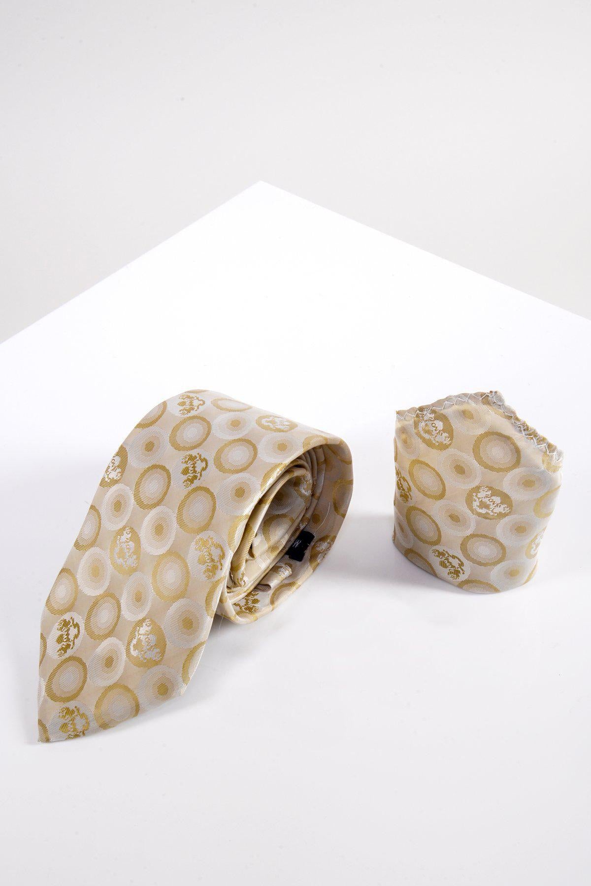 The Marc Darcy BUBBLES - Stone Circle Print Tie and Pocket Square Set features a multi-tonal gold and white circle design, showcased on a crisp white geometric background.