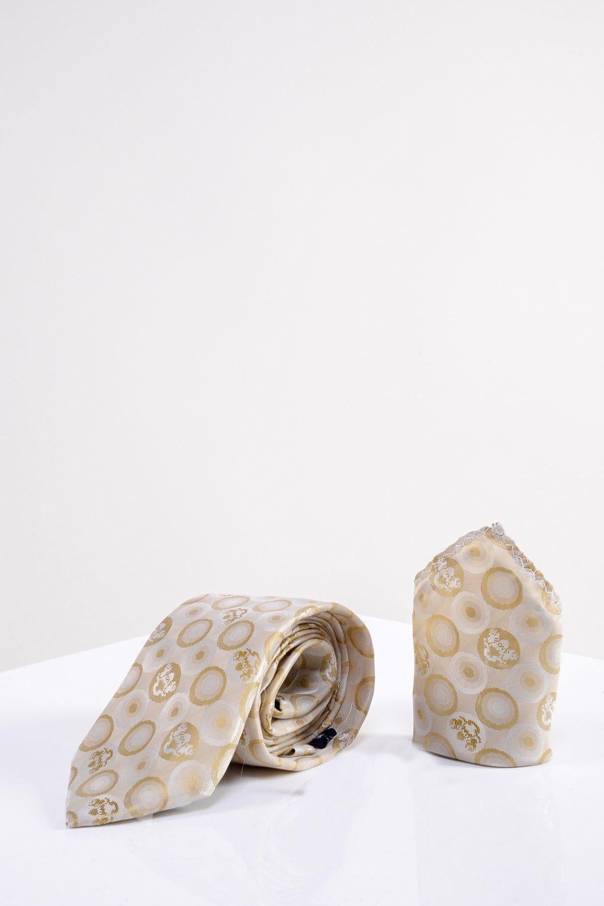 The Marc Darcy BUBBLES - Stone Circle Print Tie and Pocket Square Set, featuring a multi-tonal gold and pale yellow circular design, is displayed on a white surface against a plain white background.