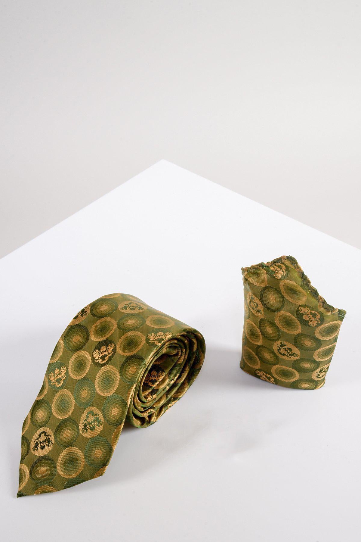 The Marc Darcy BUBBLES Tan Bubble Circle Print Tie and Pocket Square Set, featuring yellow circular patterns and subtle MD logo prints, is displayed on a white surface with a light gray background—a refined formalwear choice.