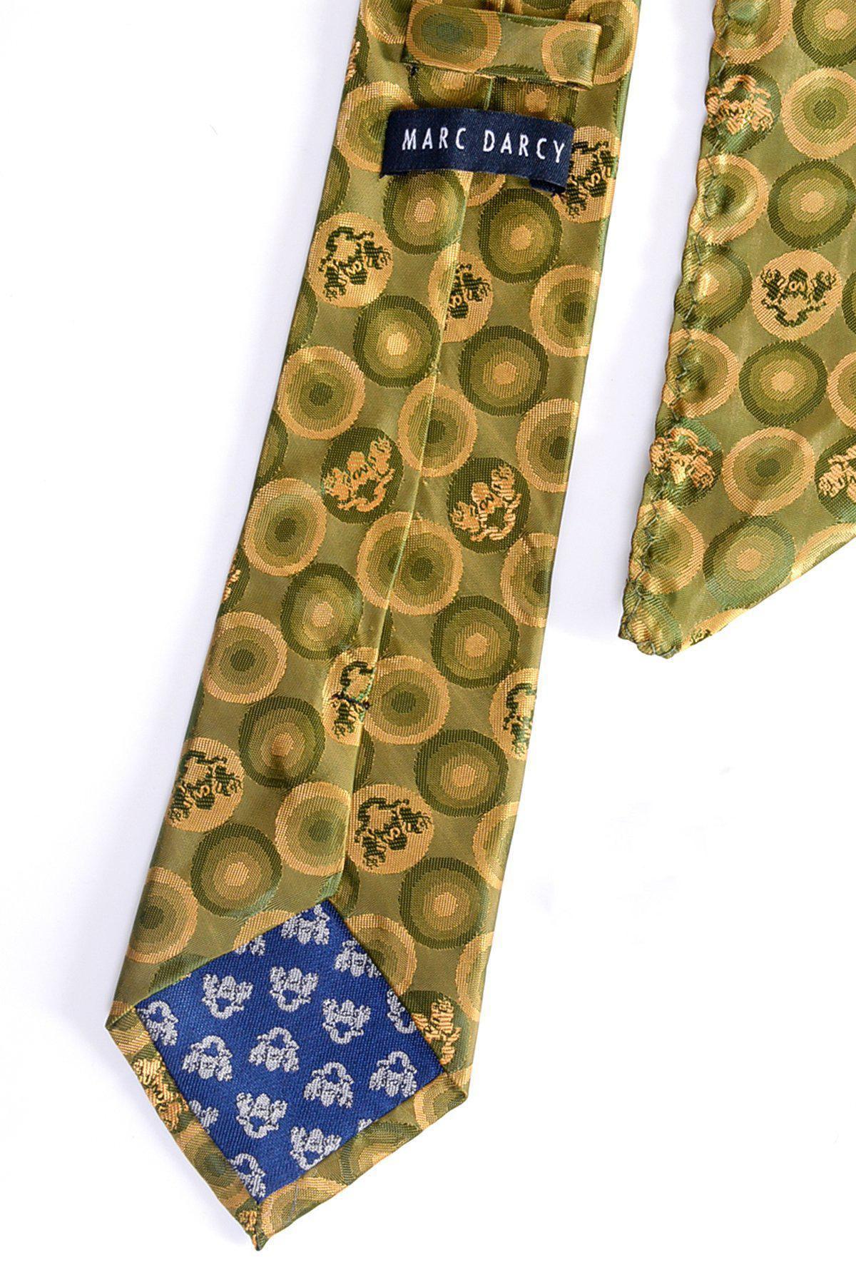 The BUBBLES - Tan Bubble Circle Print Tie and Pocket Square Set by Marc Darcy features tan and yellow bubble patterns, the MD logo label, and a contrasting blue tip with white floral motifs, all displayed on a white background.
