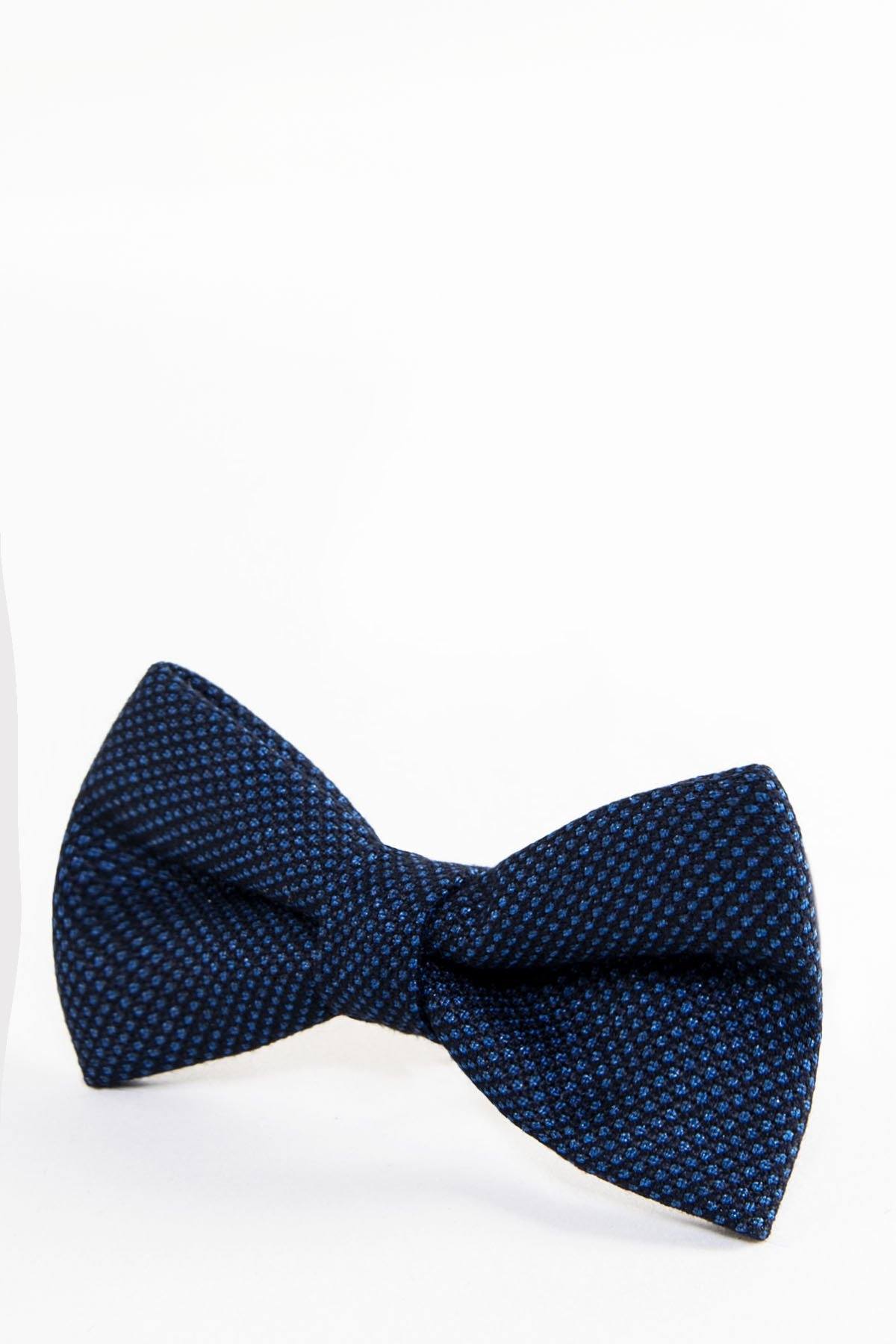 The CALLUM - Navy Blue Birdseye Bow Tie by Accessory features a birdseye weave with small light blue dots, shown on a plain white background.