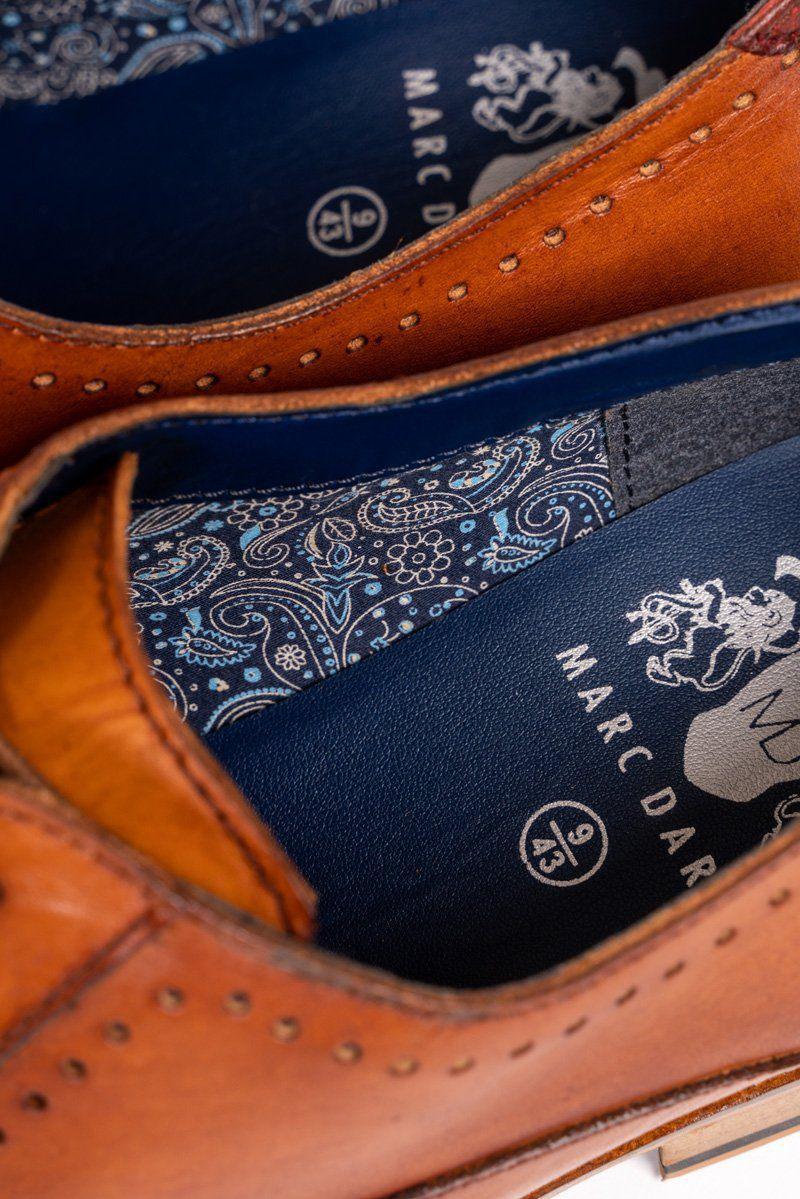 Close-up of the inside of CARSON - Mid Tan Wingtip Oxford Brogue Shoes by Marc Darcy, featuring detailed blue insoles with a white floral paisley pattern, plus Marc Darcy branding and size markings.