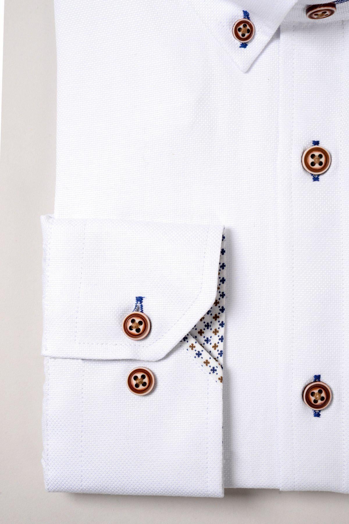 The CHARLIE White Oxford Shirt by Marc Darcy features tan buttons, blue thread accents, and visible cuffs with subtle blue and beige patterned inner seams for a smart casual look.