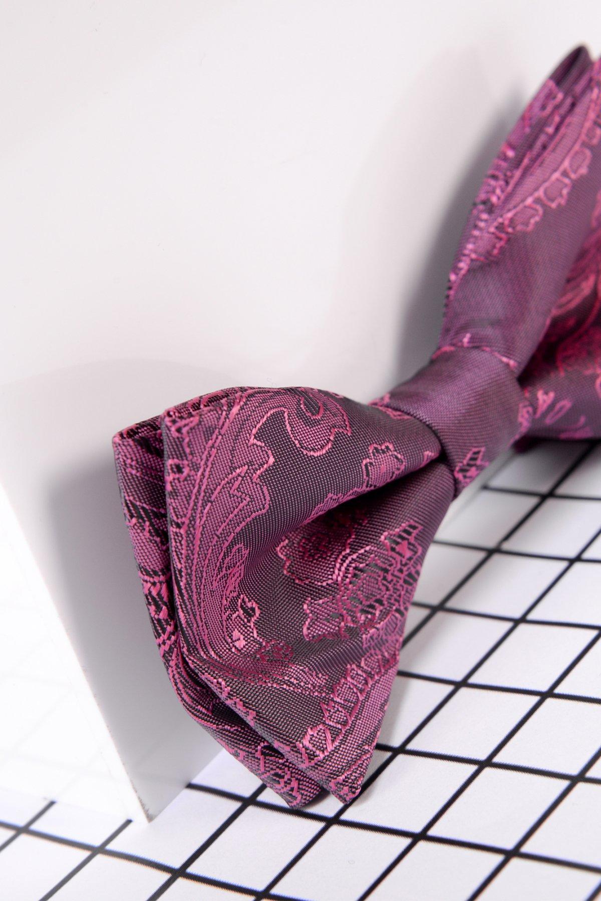 The Marc Darcy Childrens Berry Paisley Print Bow Tie features an adjustable neck strap and rests on a white surface with a grid-patterned background—ideal for pairing with a boys Harry suit.