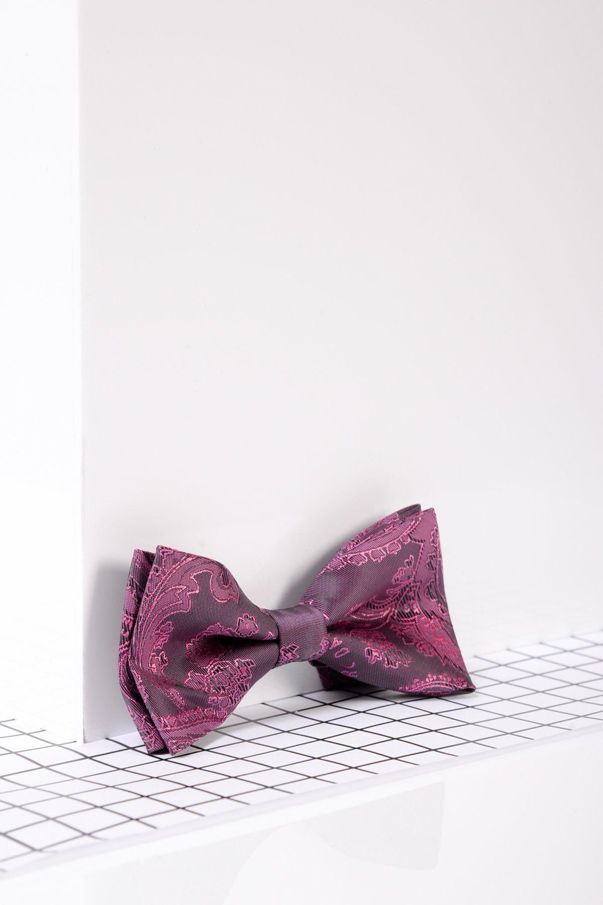 The Marc Darcy Children's Berry Paisley Print Bow Tie is displayed against a white wall and grid-patterned floor, highlighting its modern, minimalist style—making it the perfect boys formal accessory.